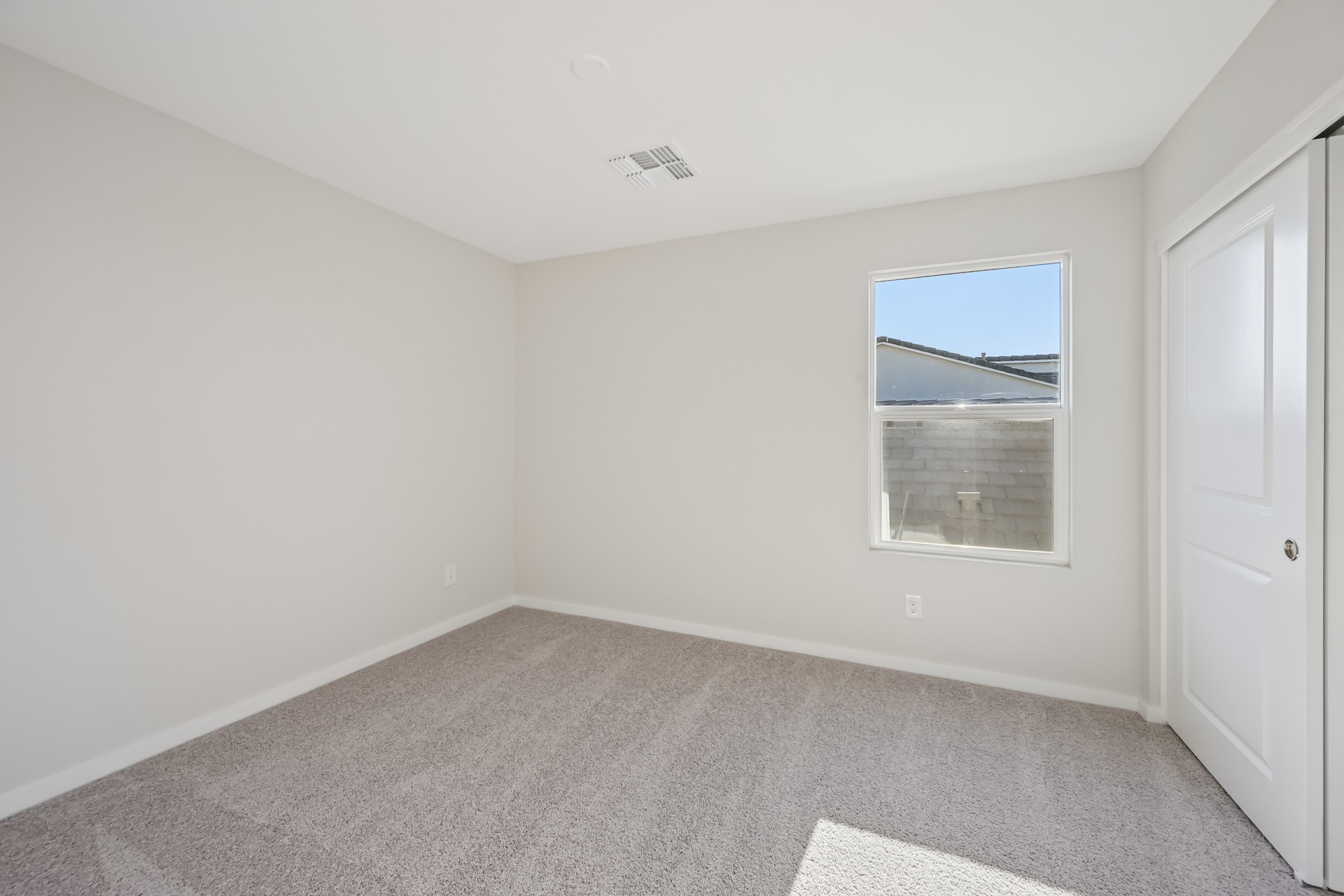 A room with a window and a door.