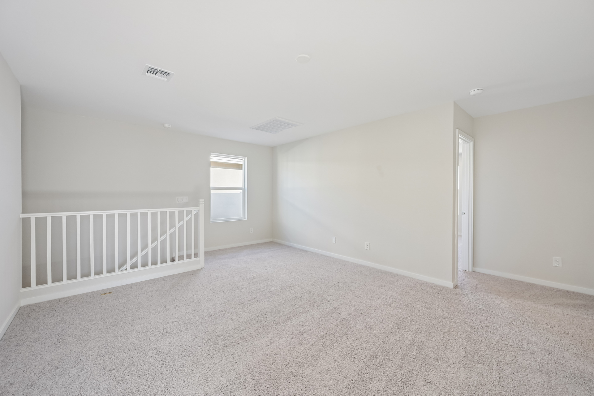A room with a white railing and a white railing.