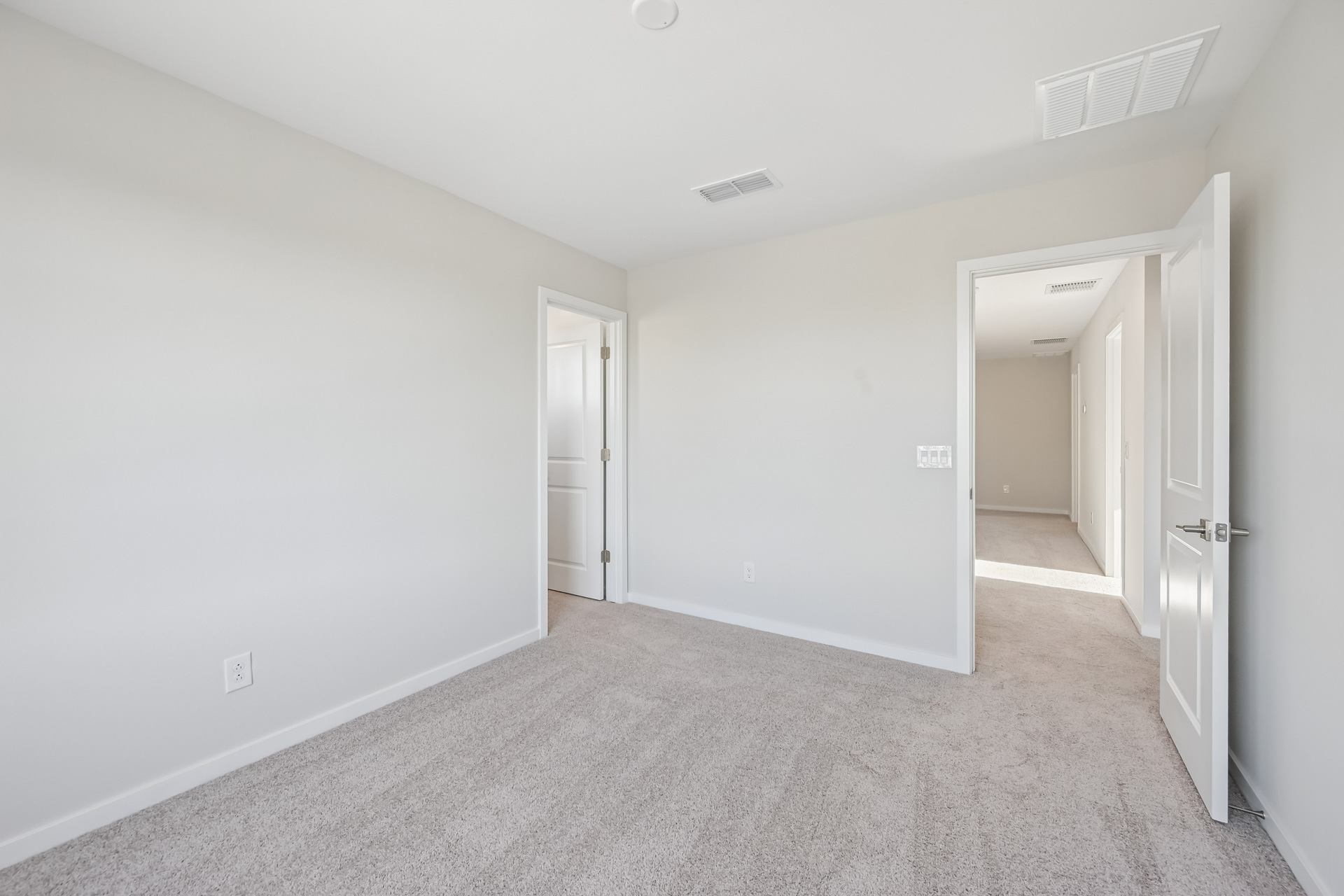 A hallway with white doors.