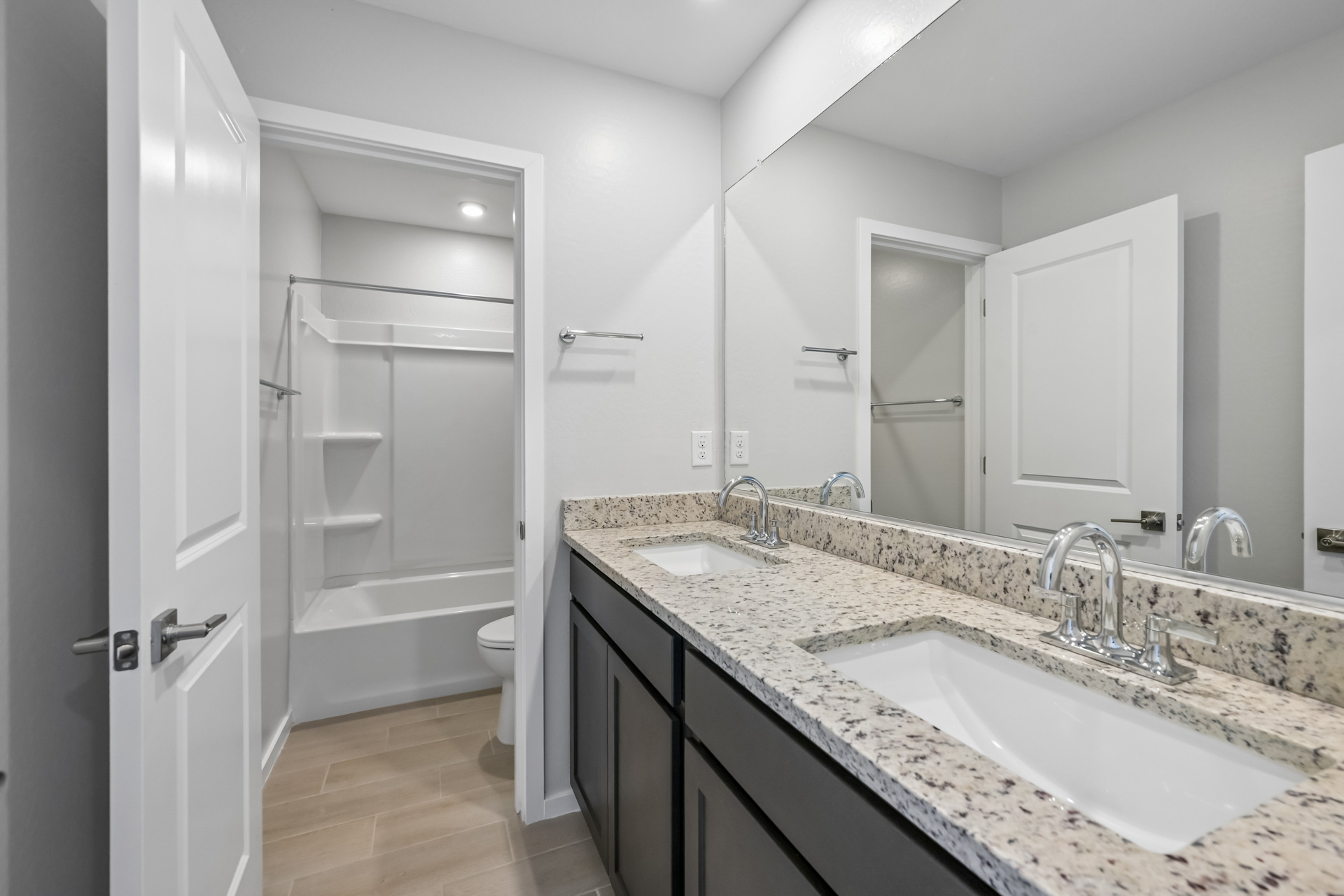 A bathroom with a large mirror.