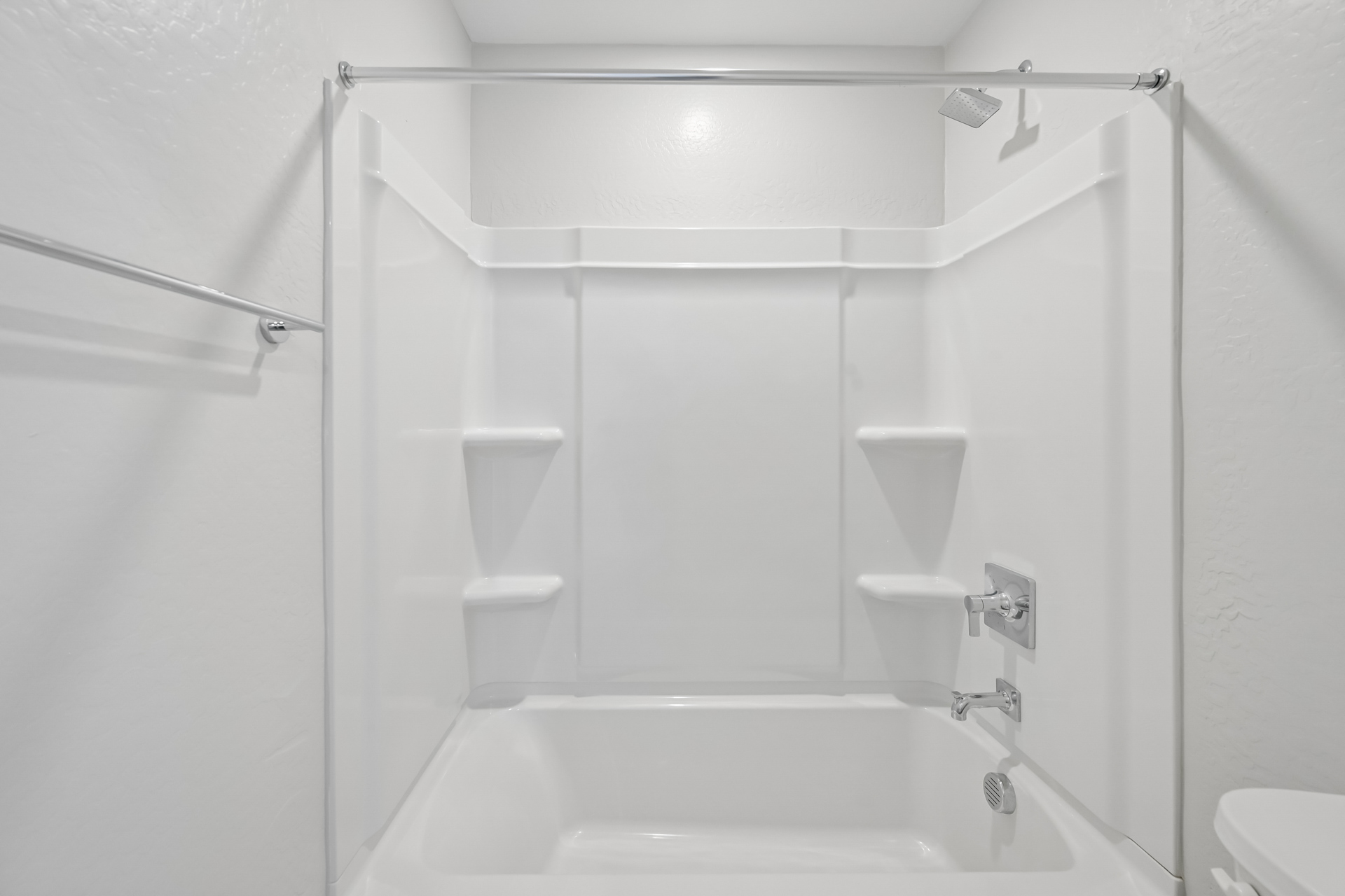 A bathroom with a bathtub and toilet.