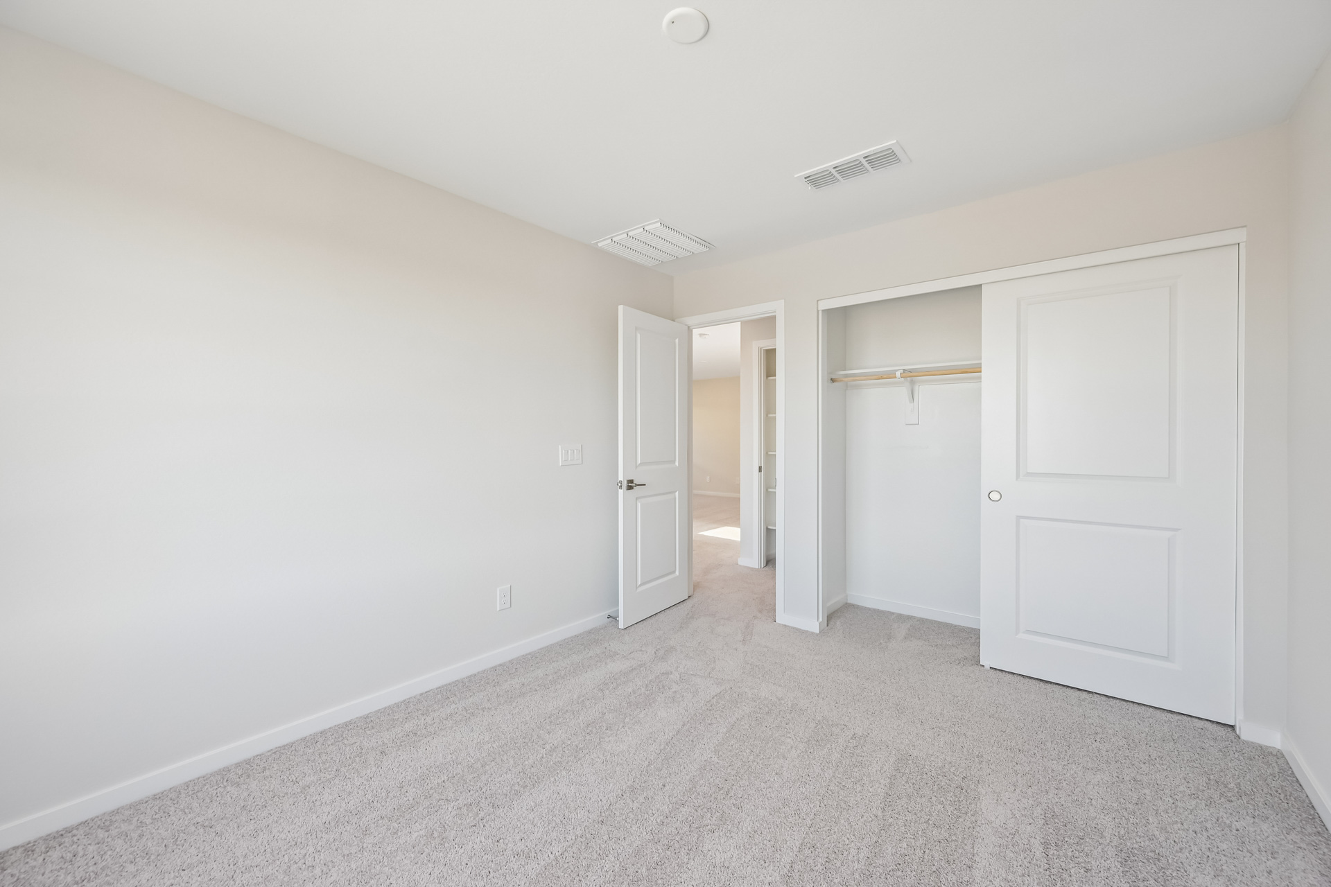 A hallway with white doors.