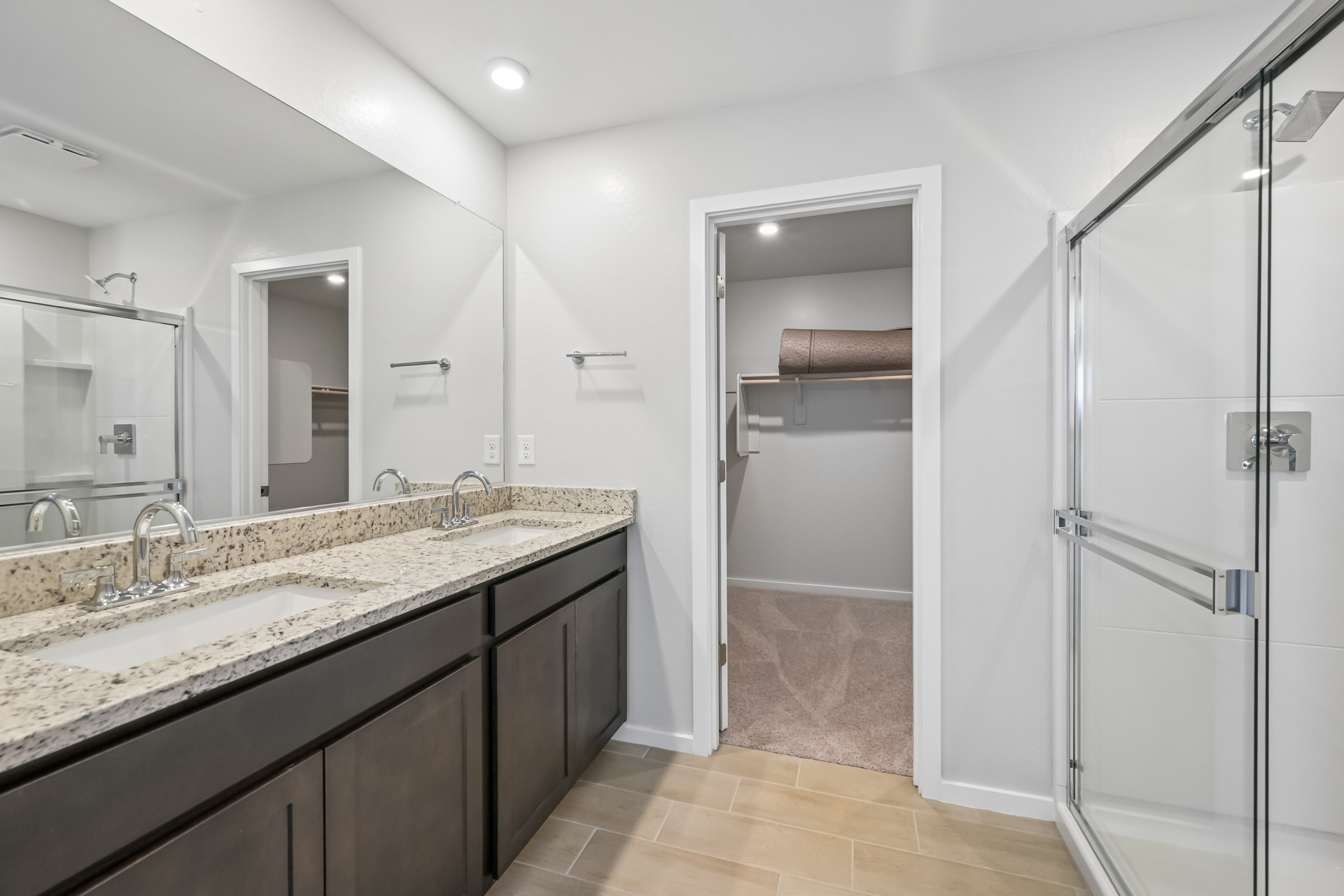 A bathroom with a shower and sink.