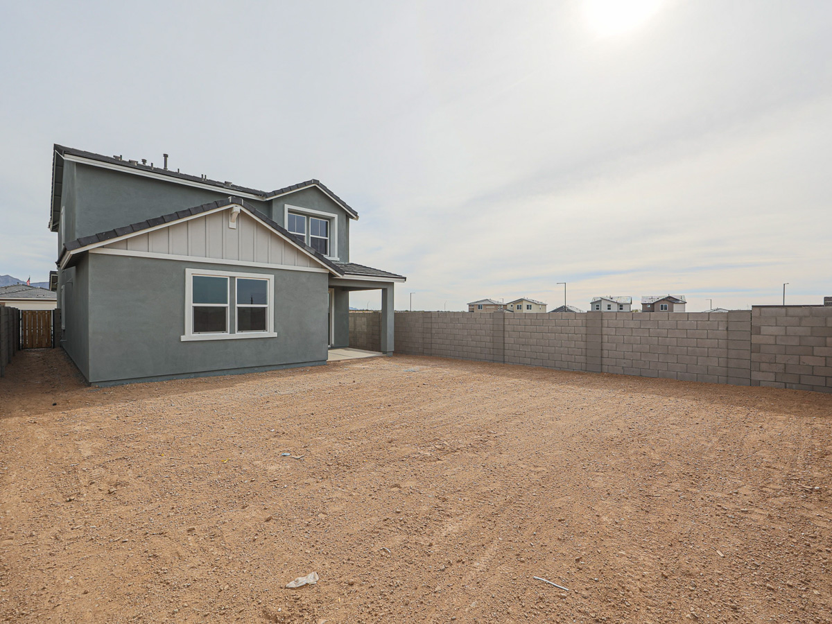 A house with a dirt yard.