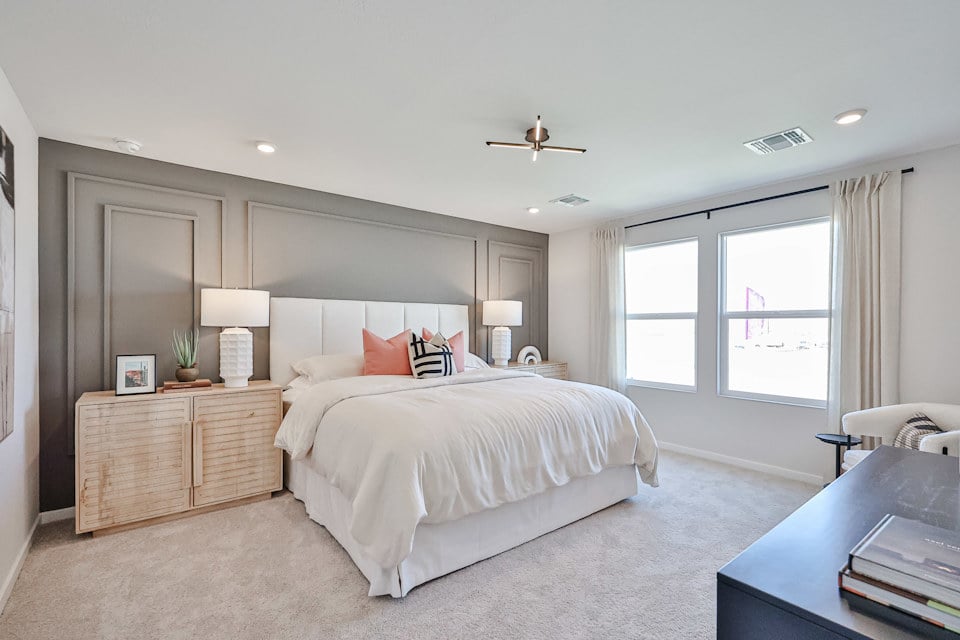 A bedroom with a bed and a desk.