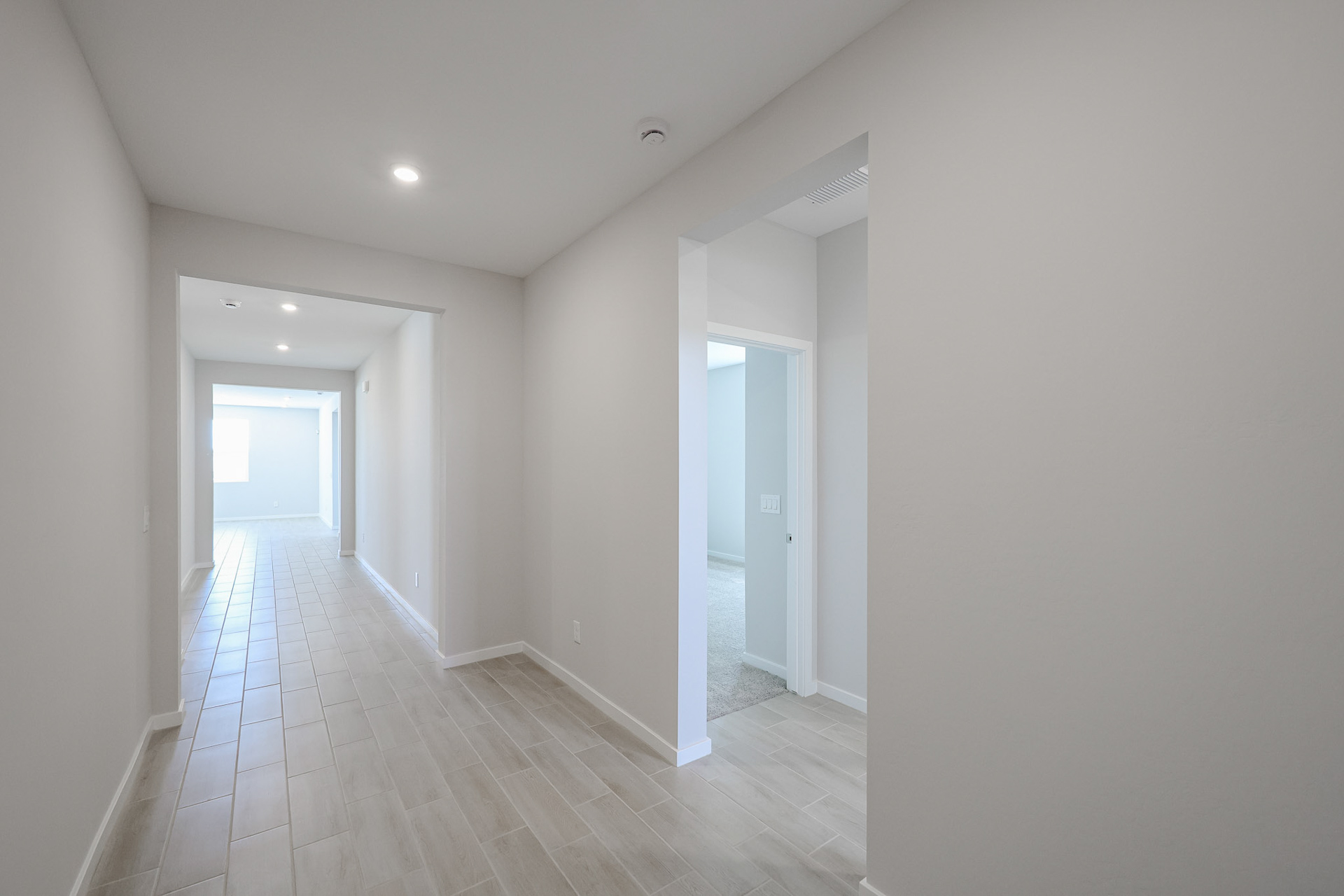 A hallway with white walls.