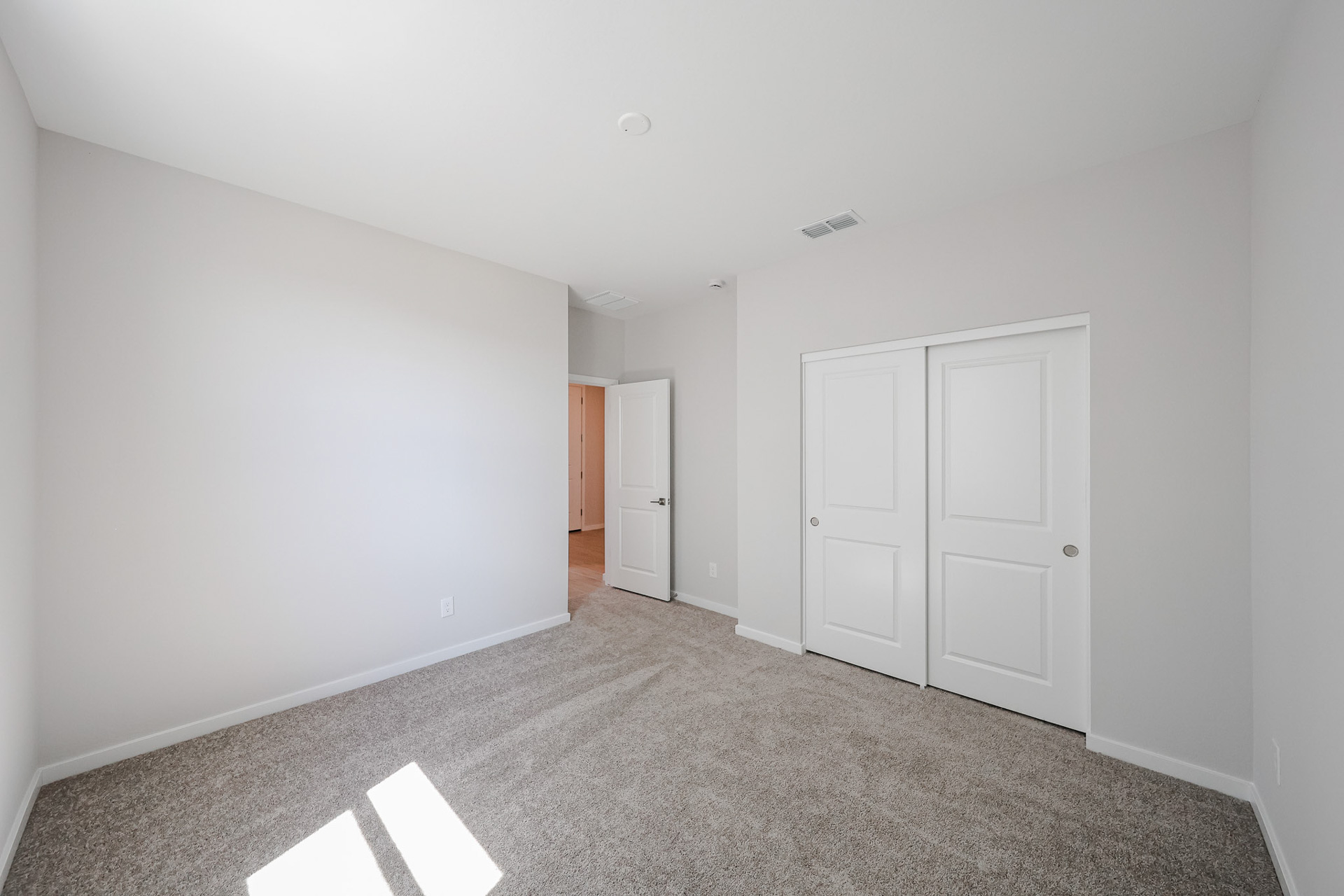A hallway with white doors.