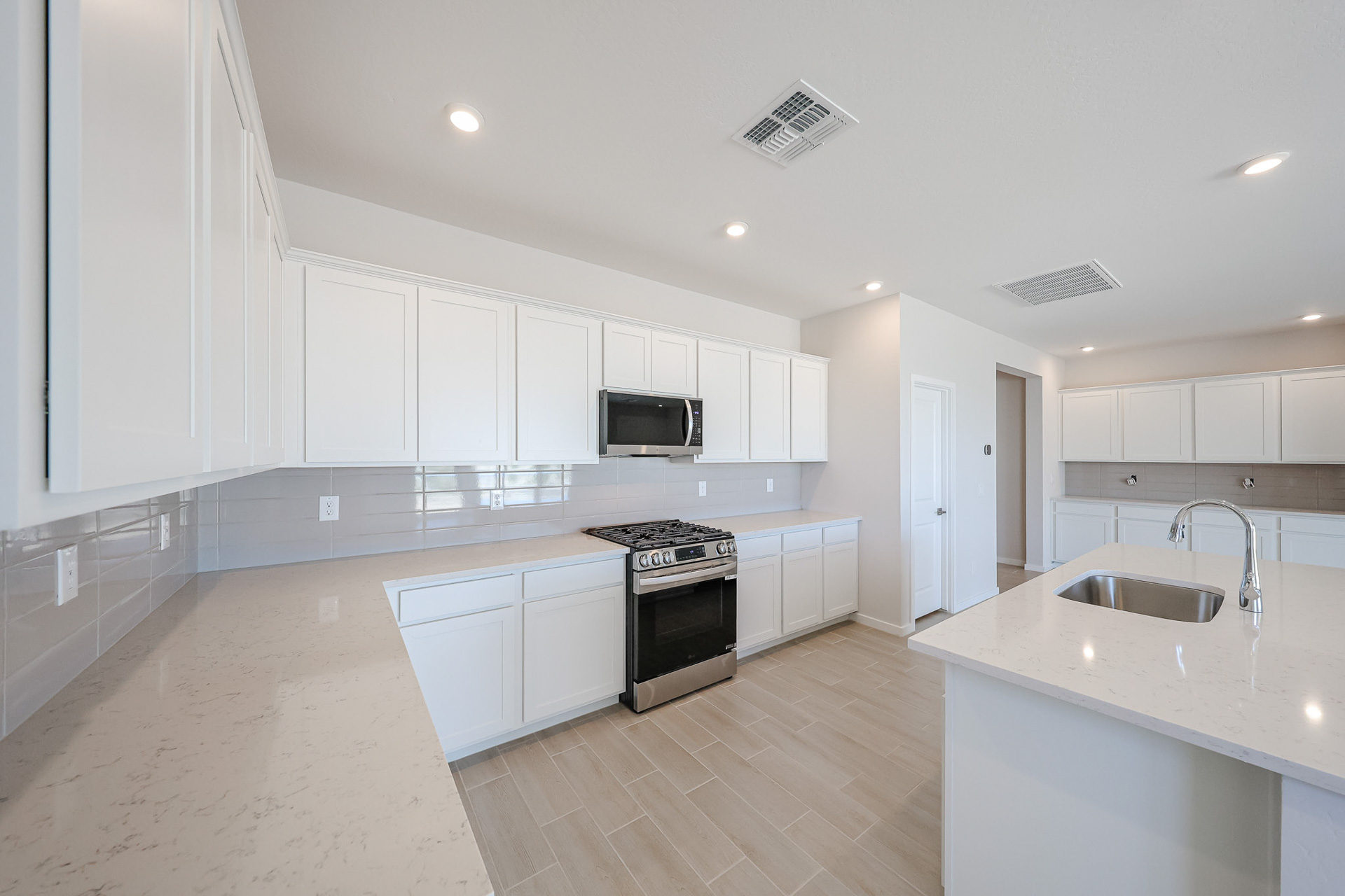 A kitchen with white cabinets.