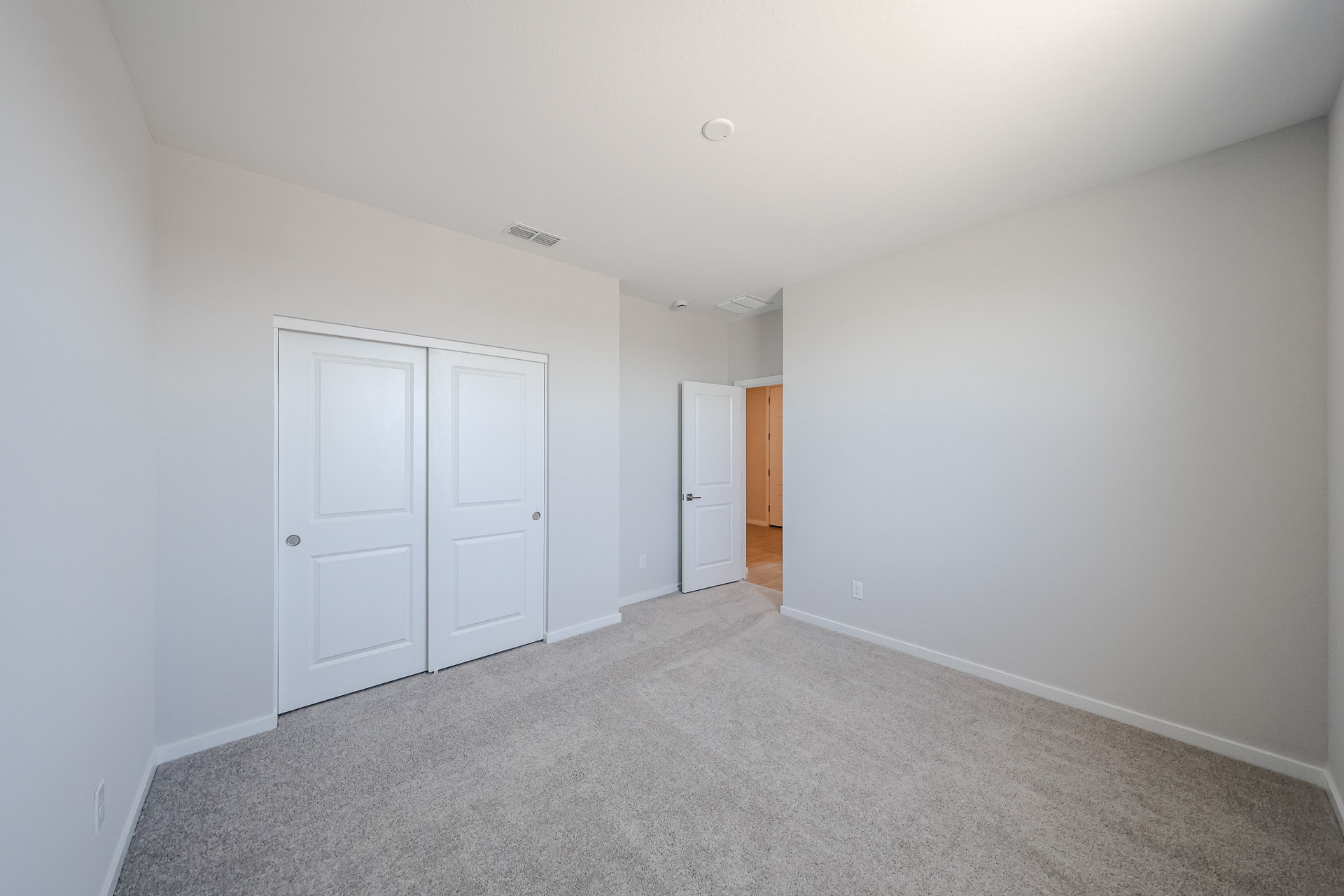 A hallway with white doors.