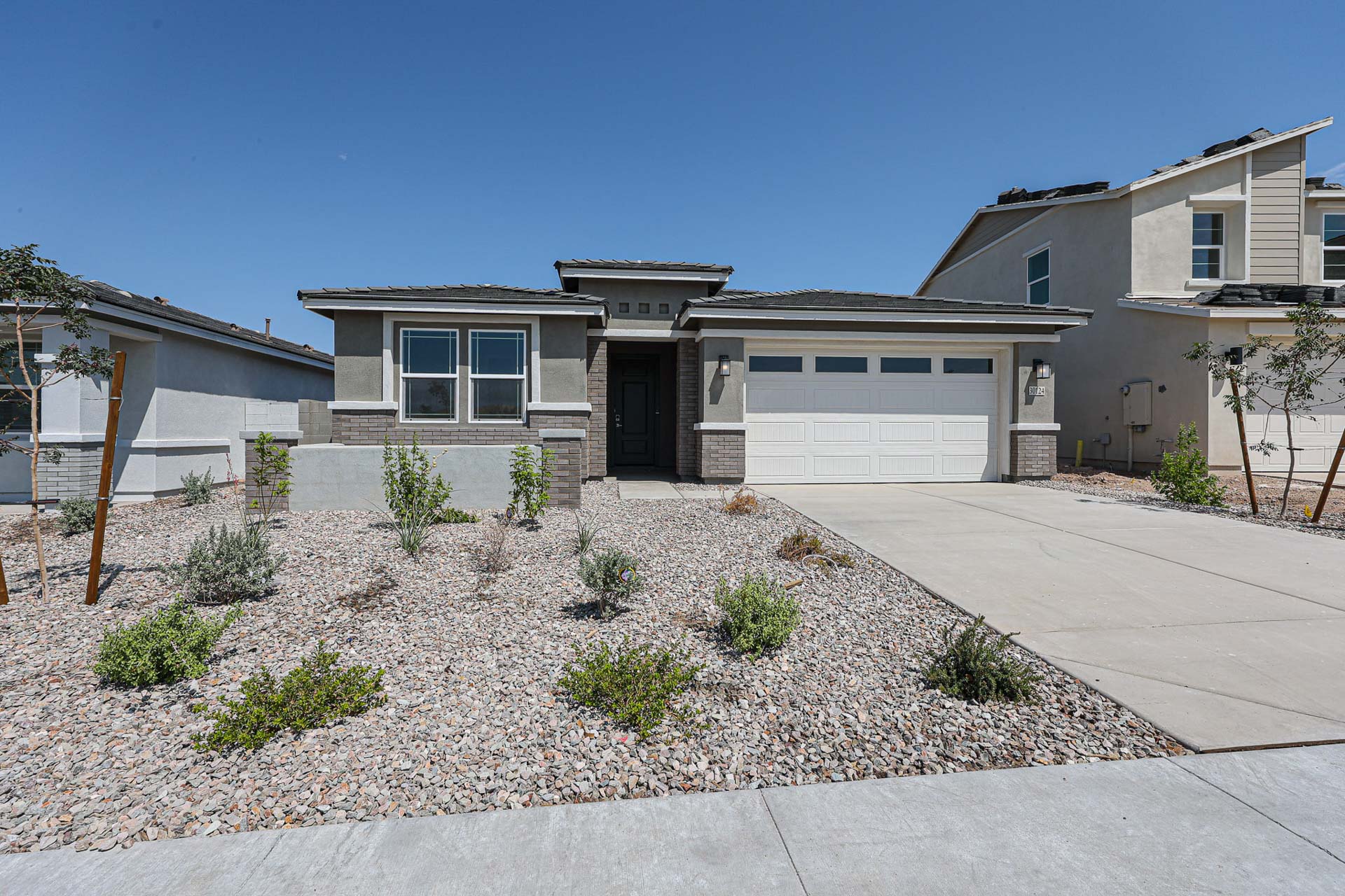 A house with a gravel driveway.