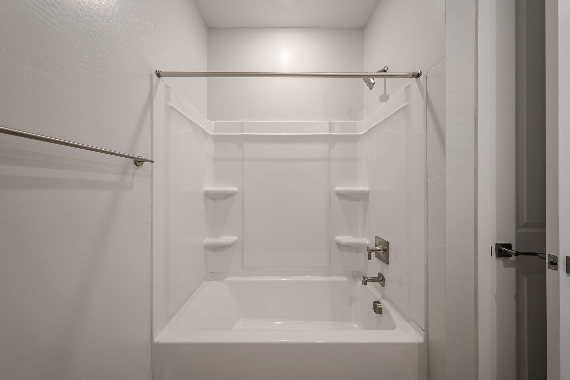 A bathroom with a bathtub and toilet.