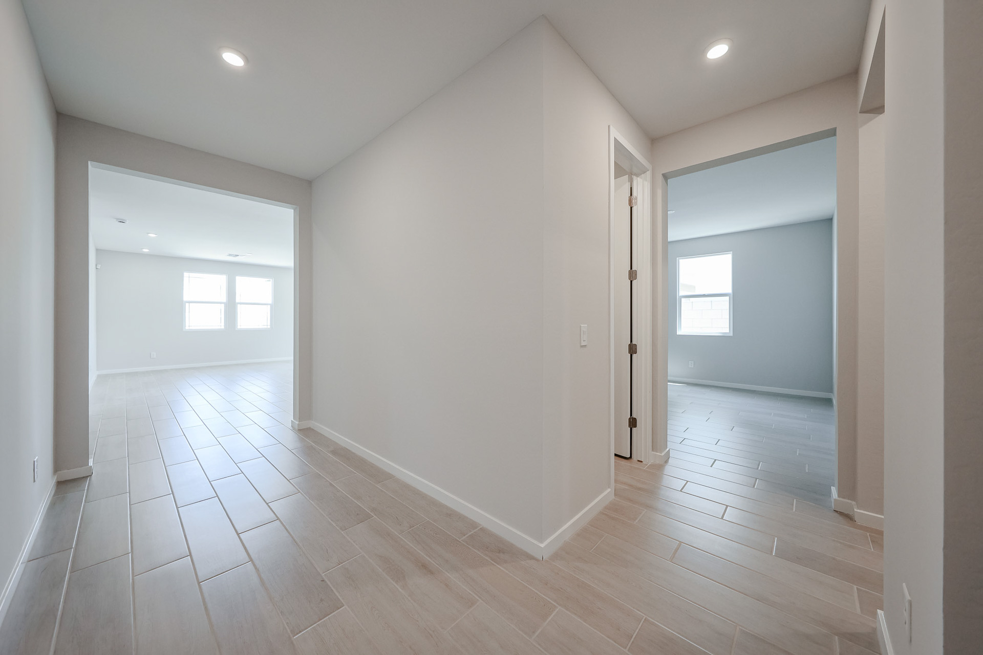 A room with white walls and wood floors.