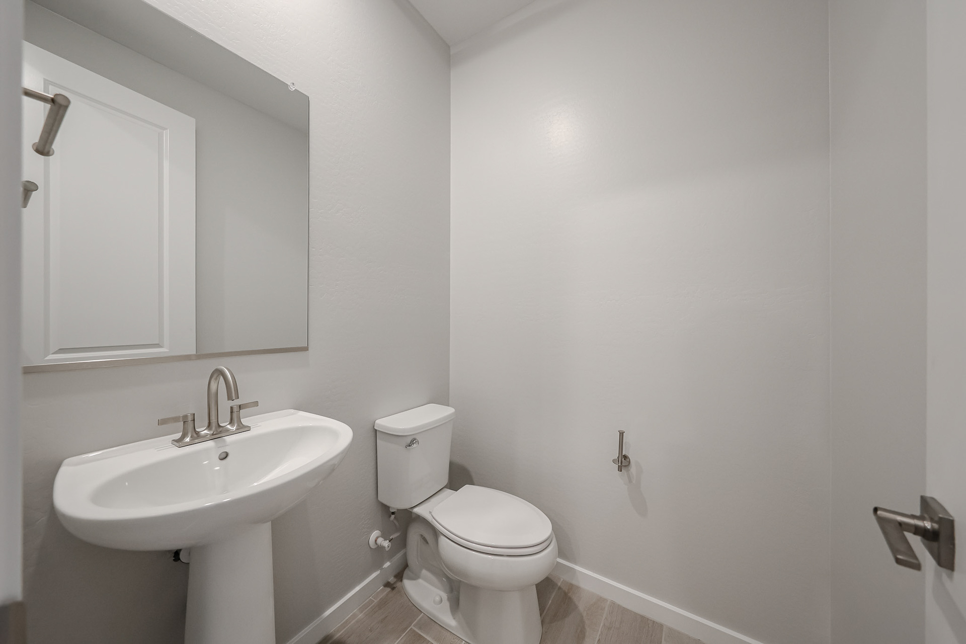 A bathroom with a toilet and sink.