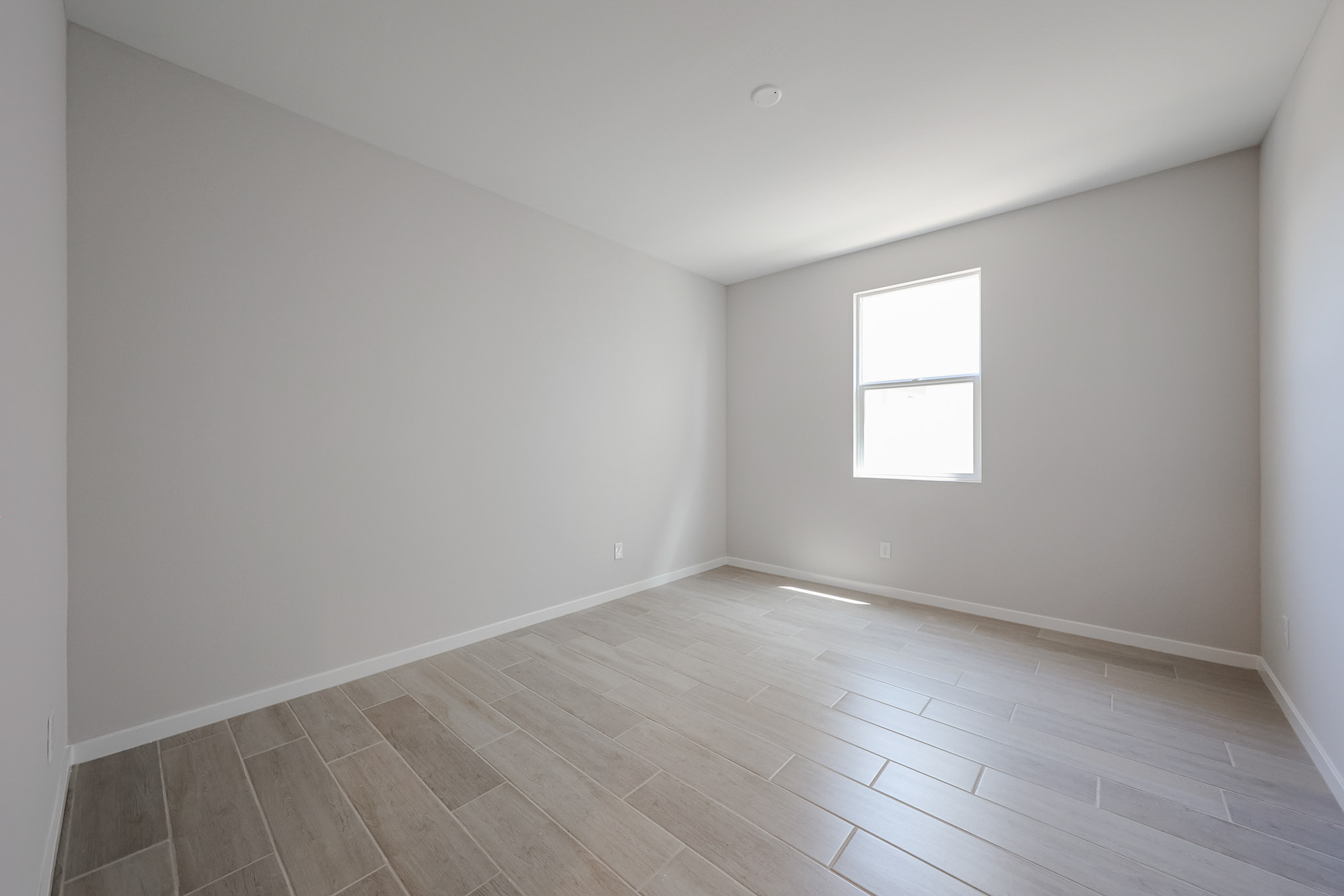 A room with a wood floor and a wood floor.