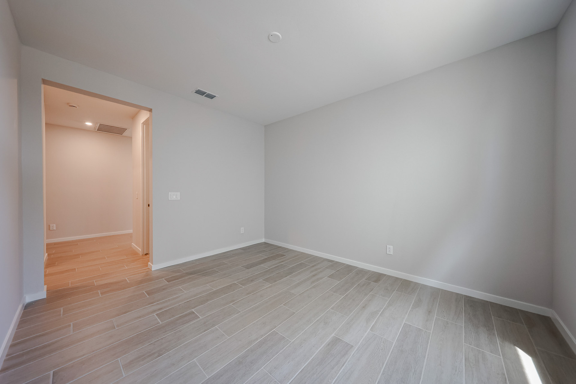A room with a wood floor and a wood floor.