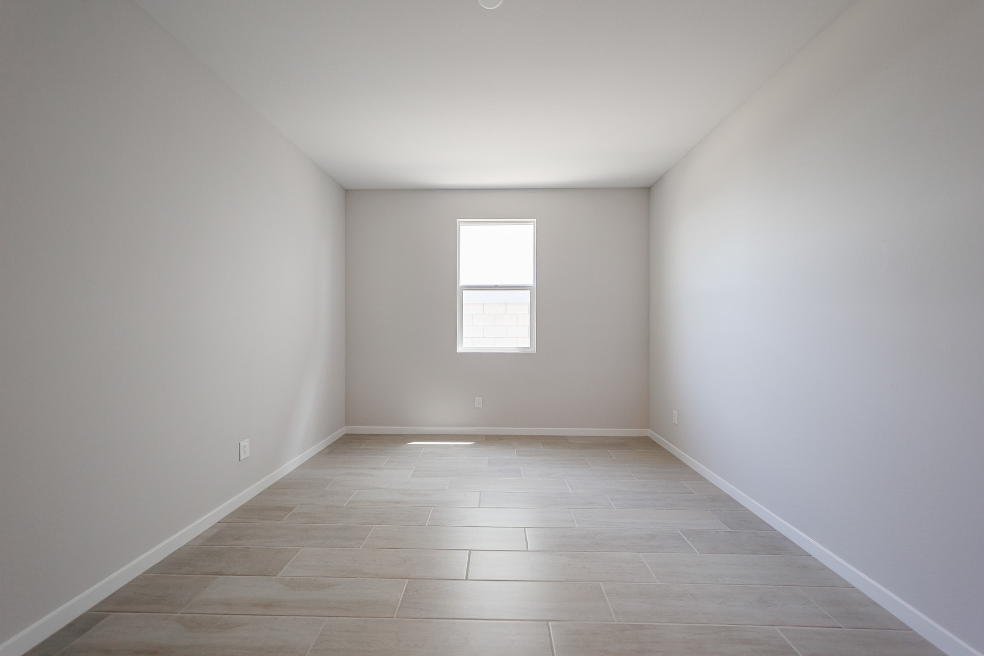 A room with a tile floor and a window.
