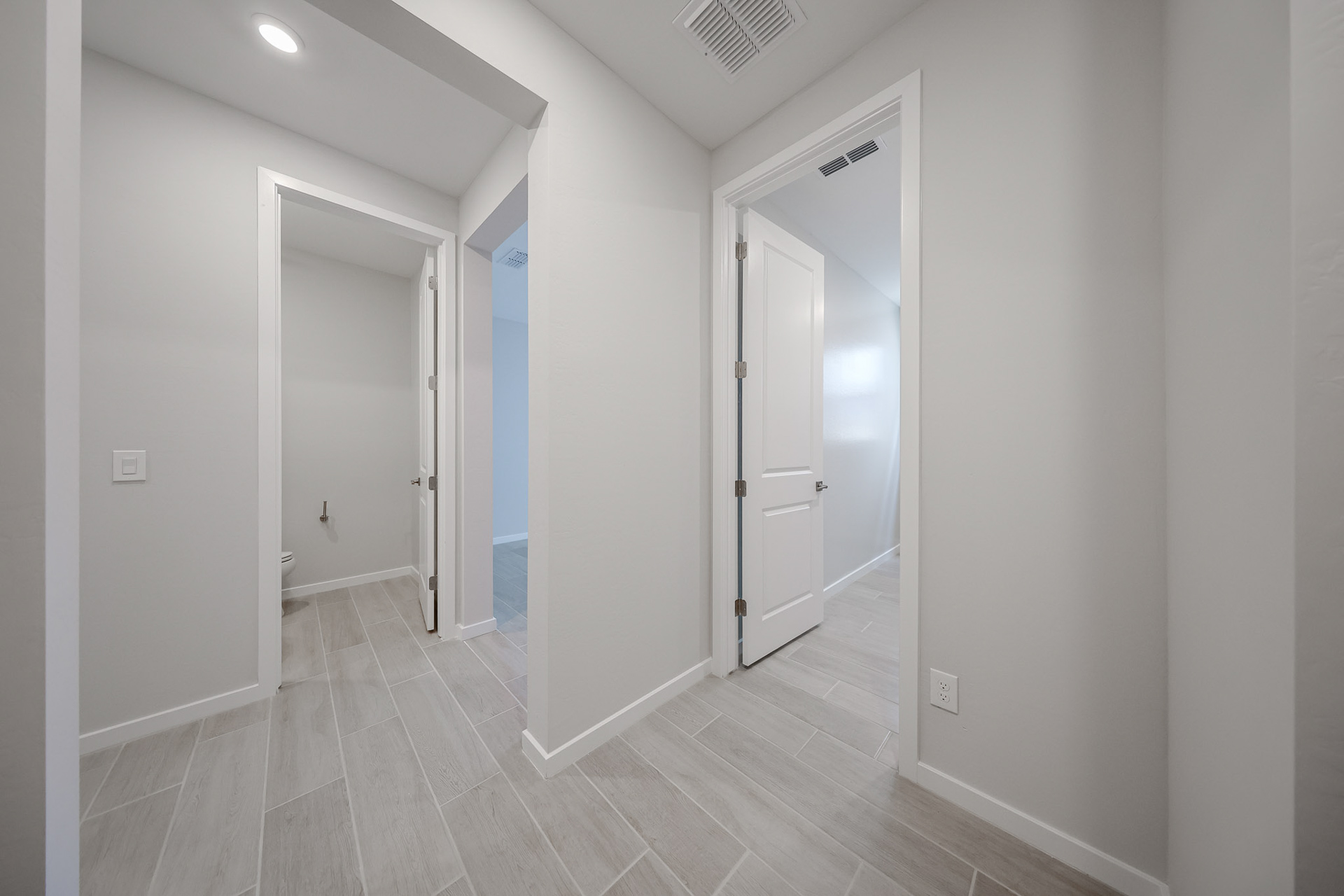 A hallway with white doors.