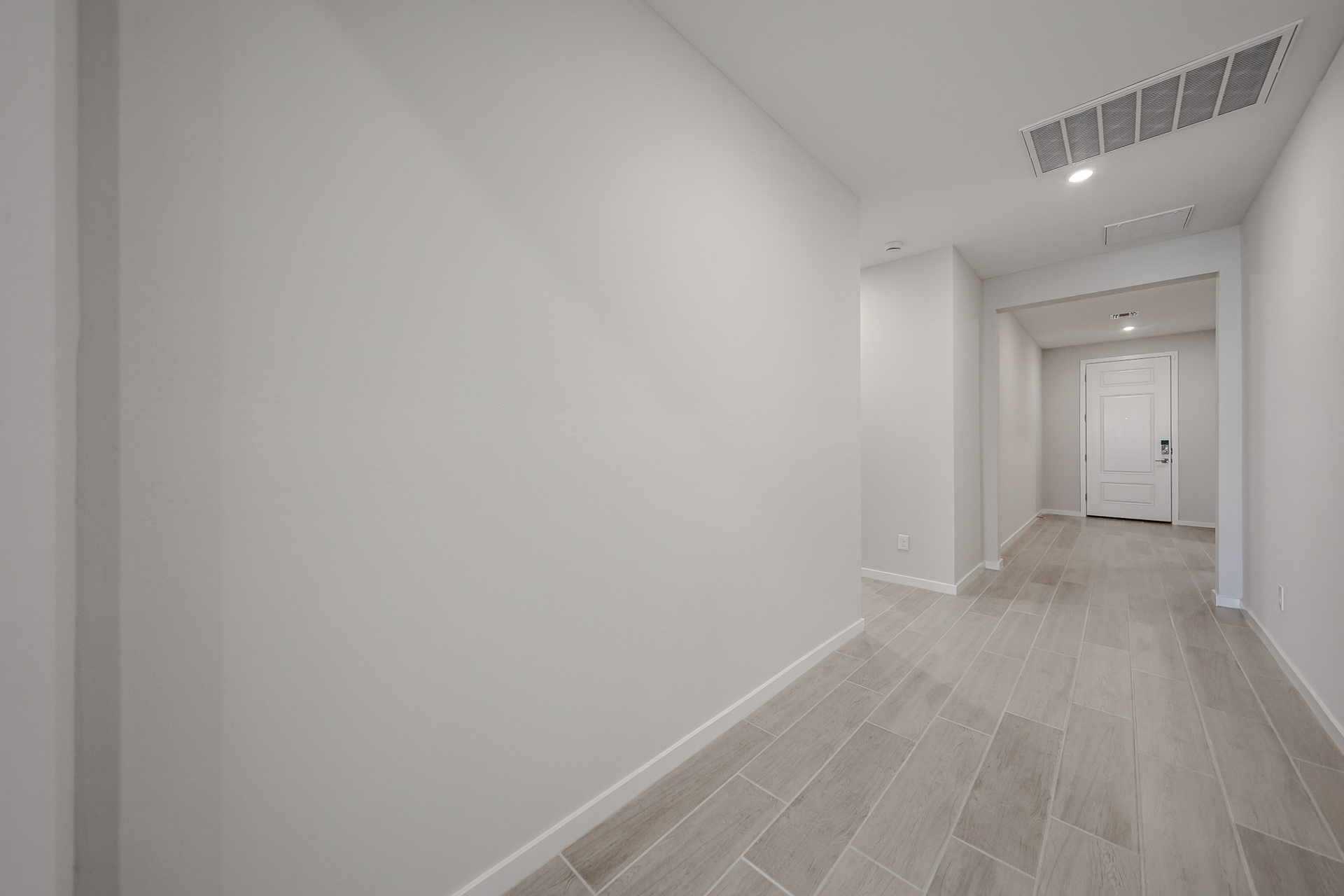 A hallway with white walls.