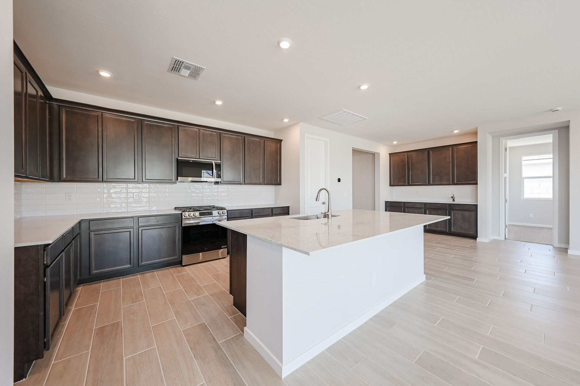 A kitchen with black cabinets.