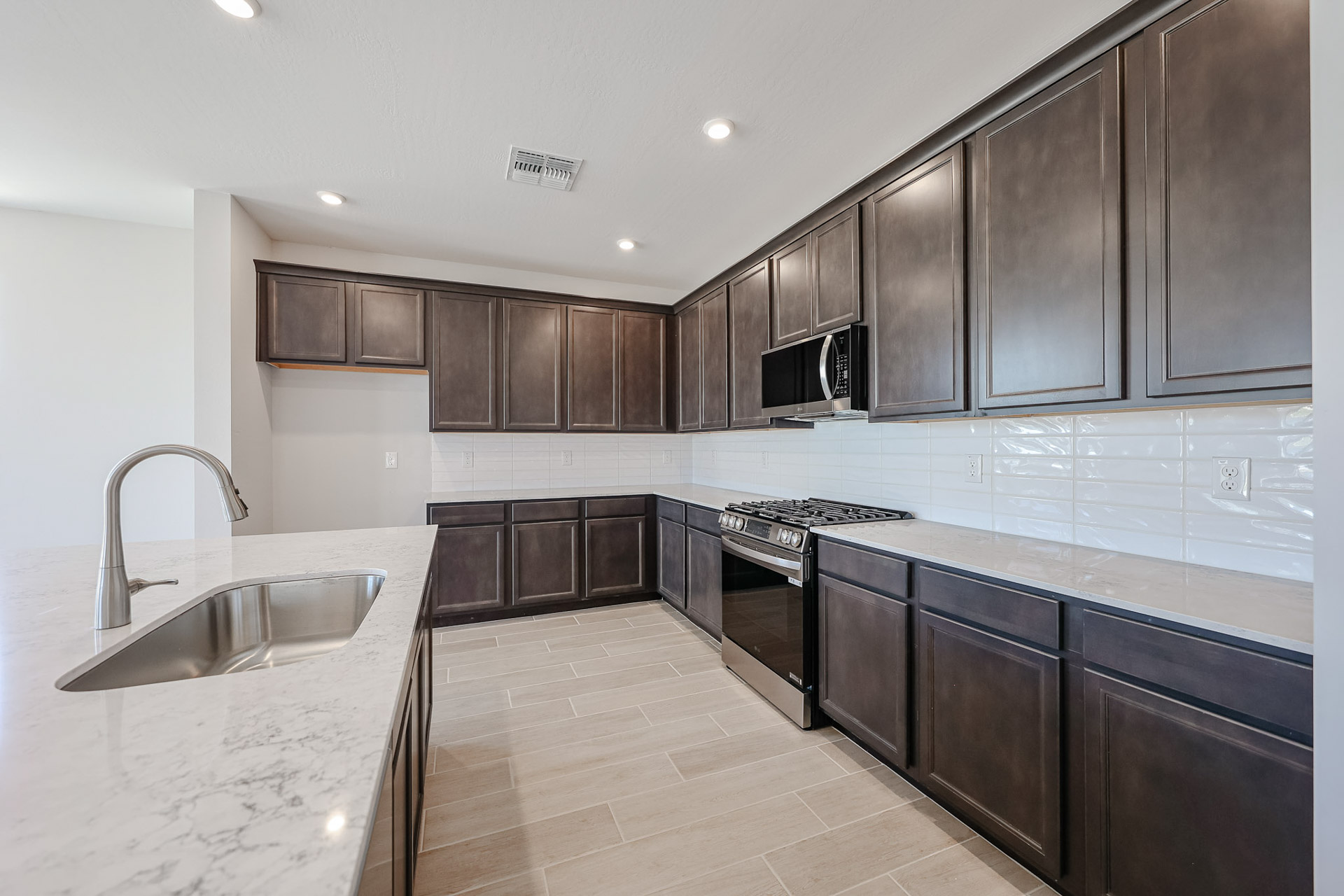 A kitchen with black cabinets.