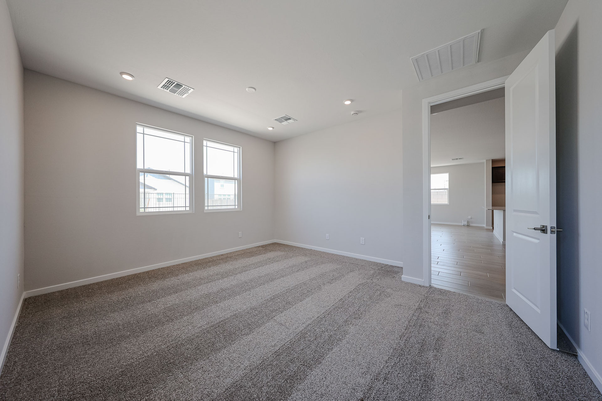 A hallway with a carpet.