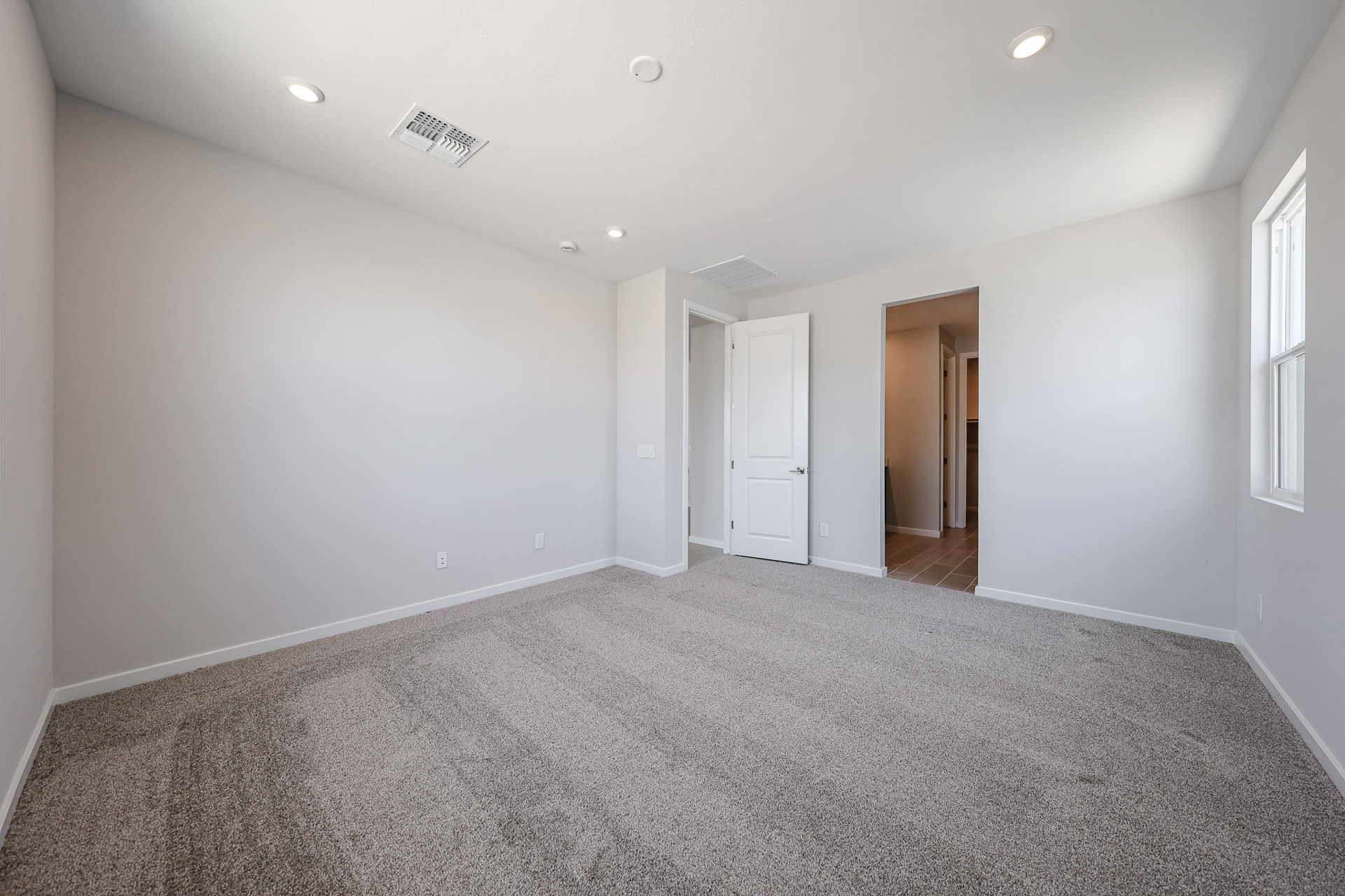 A hallway with white walls.