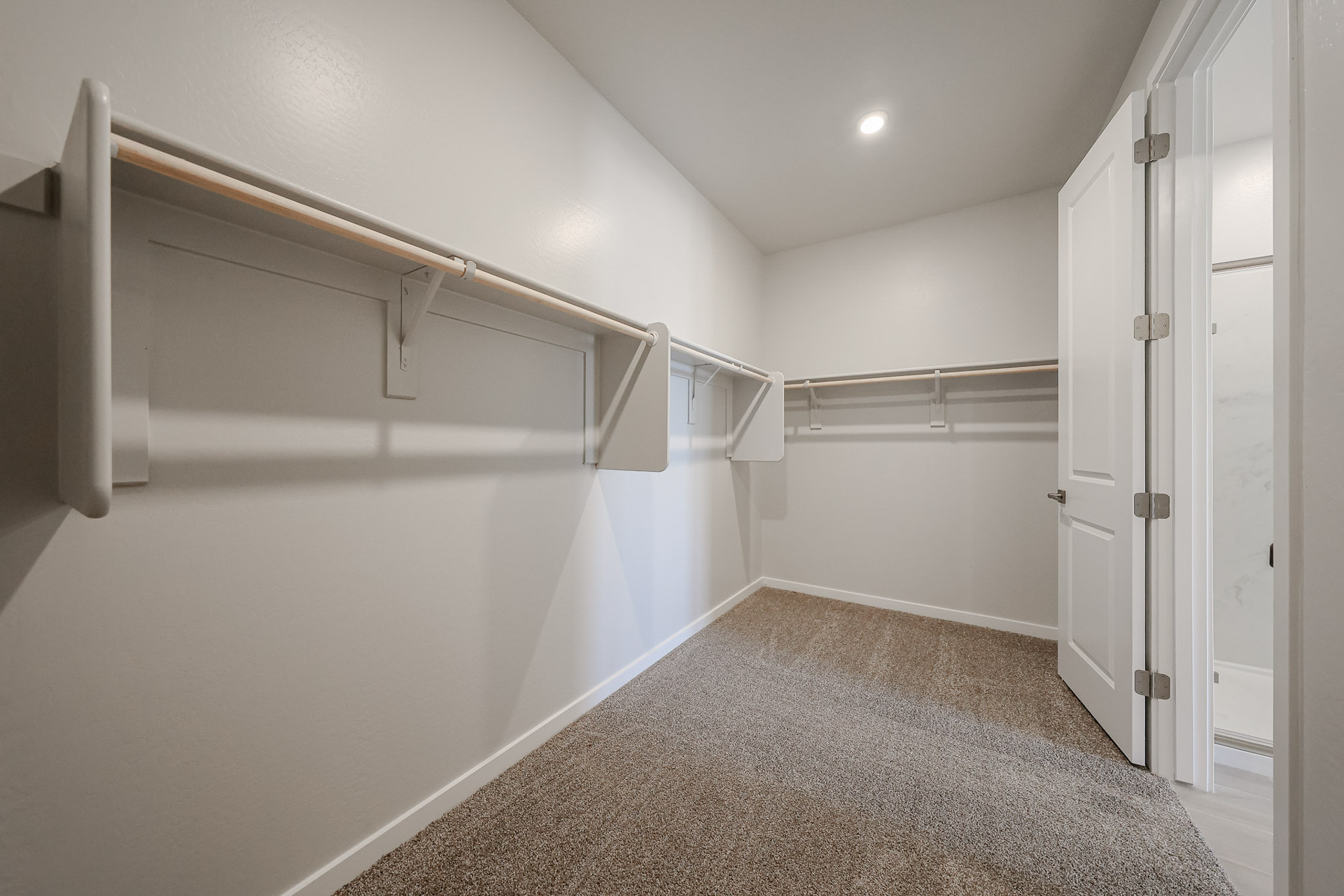 A hallway with white doors.