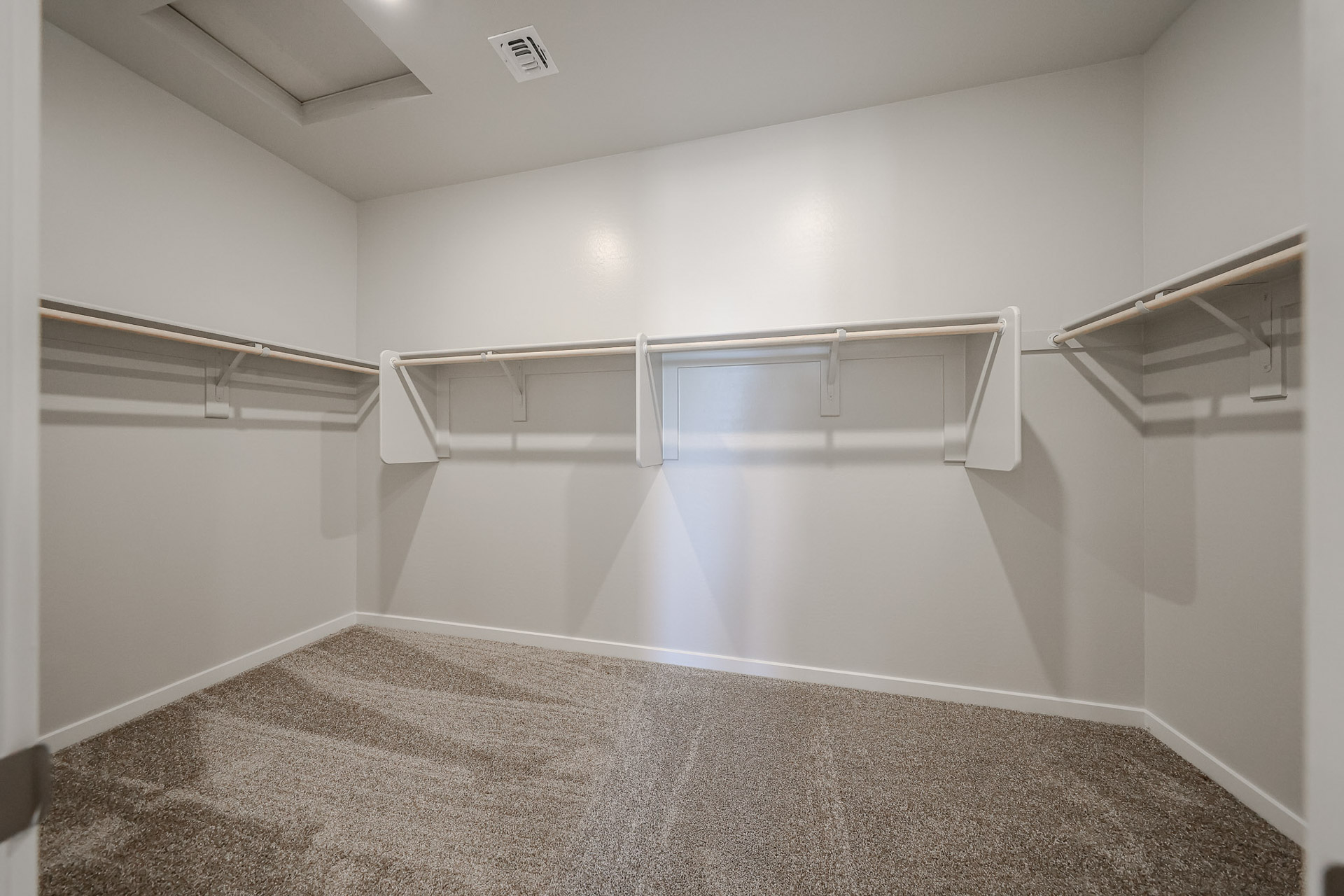 A white room with a metal railing.