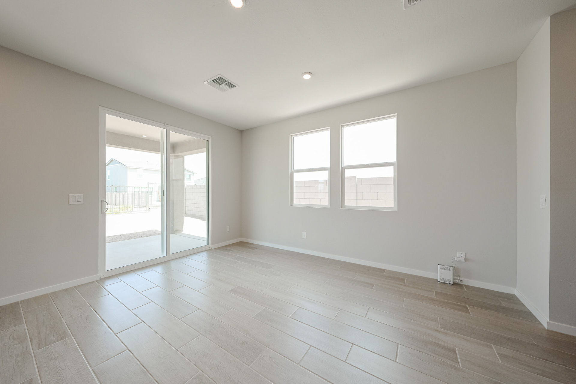 A room with a glass door and a wood floor.