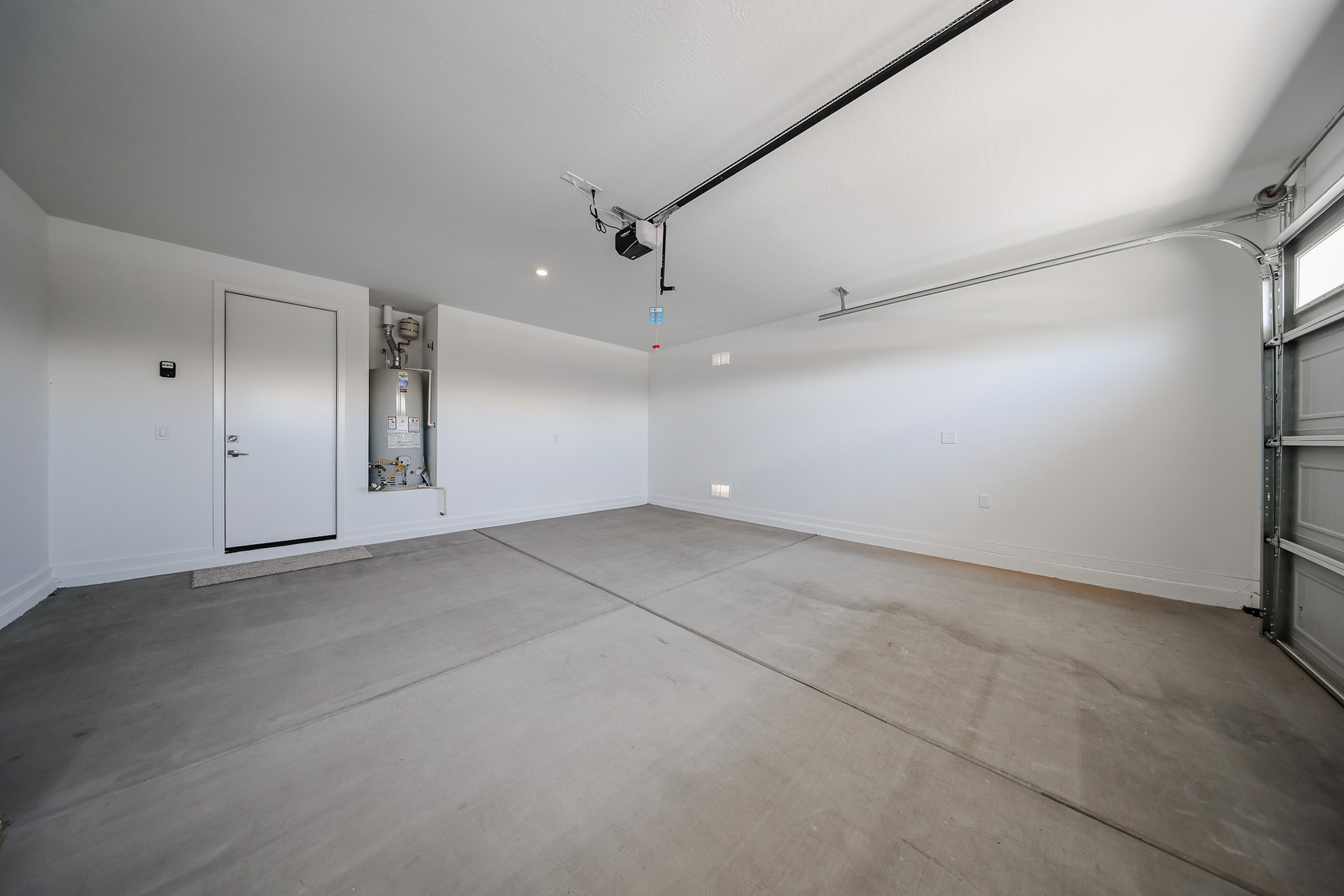 A room with white walls and a wood floor.