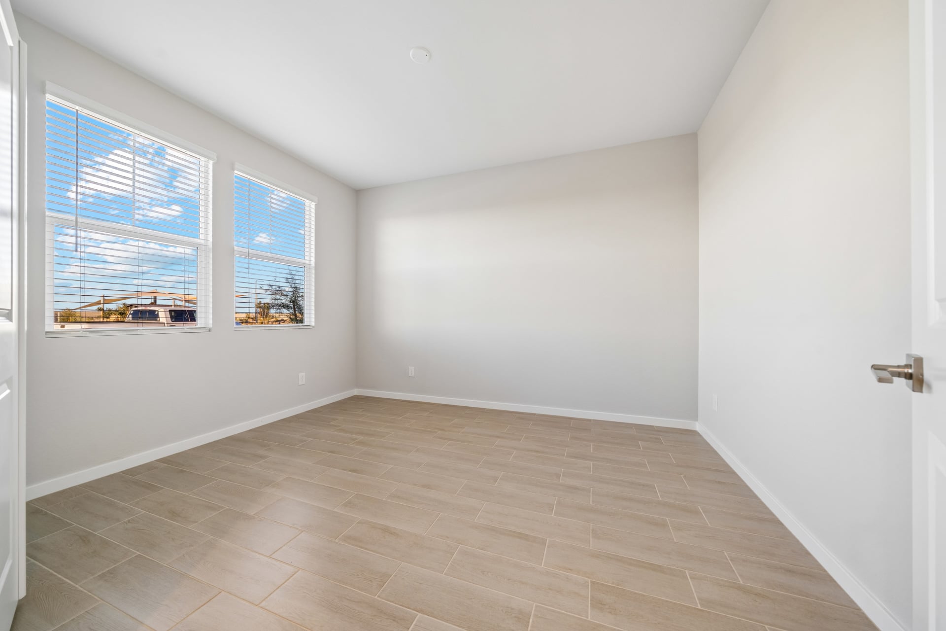 A room with a tile floor and a window.