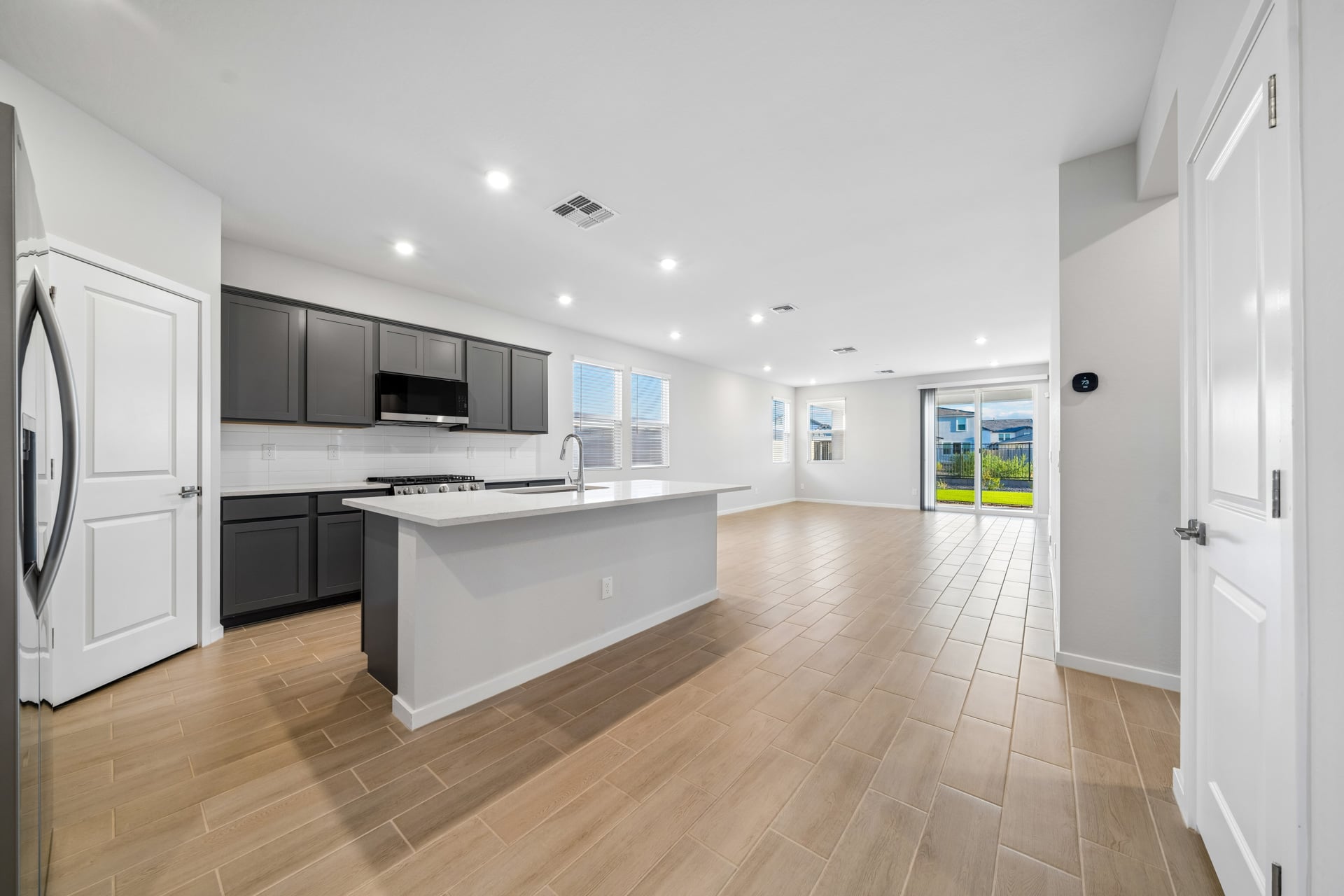 A kitchen with a wood floor.