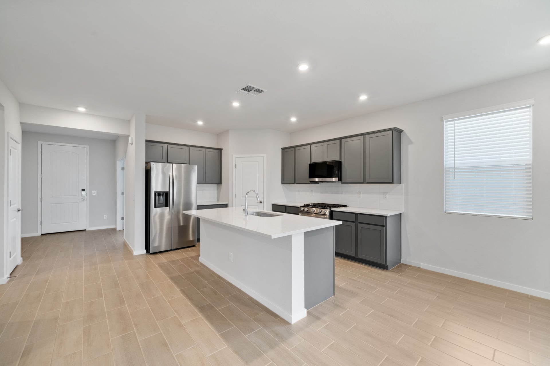 A kitchen with white cabinets.