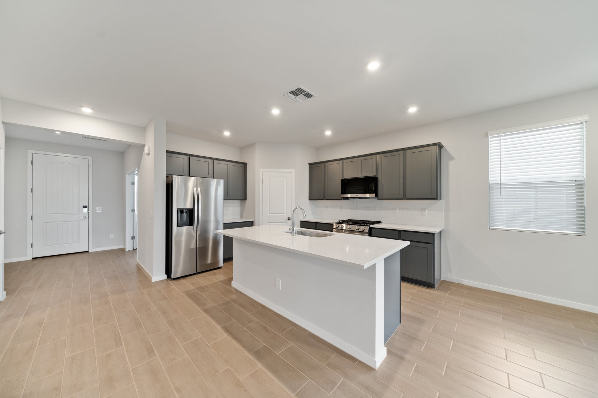 A kitchen with white cabinets.