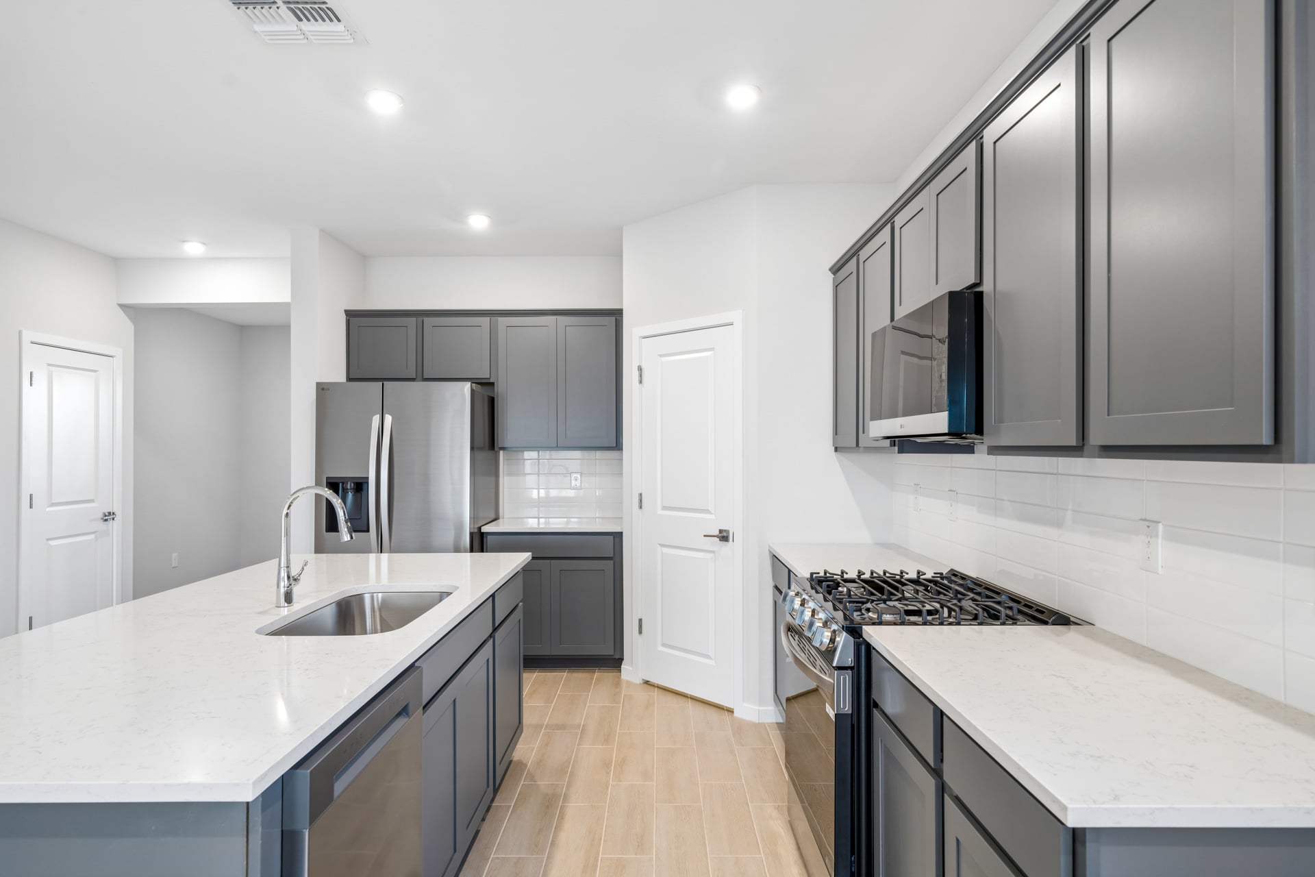 A kitchen with black cabinets.