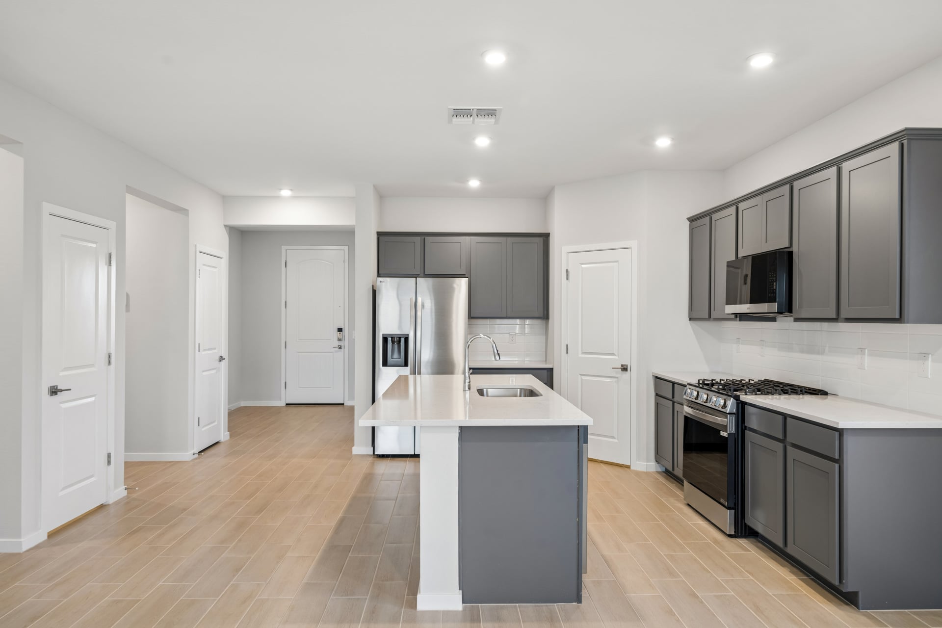 A kitchen with black cabinets.