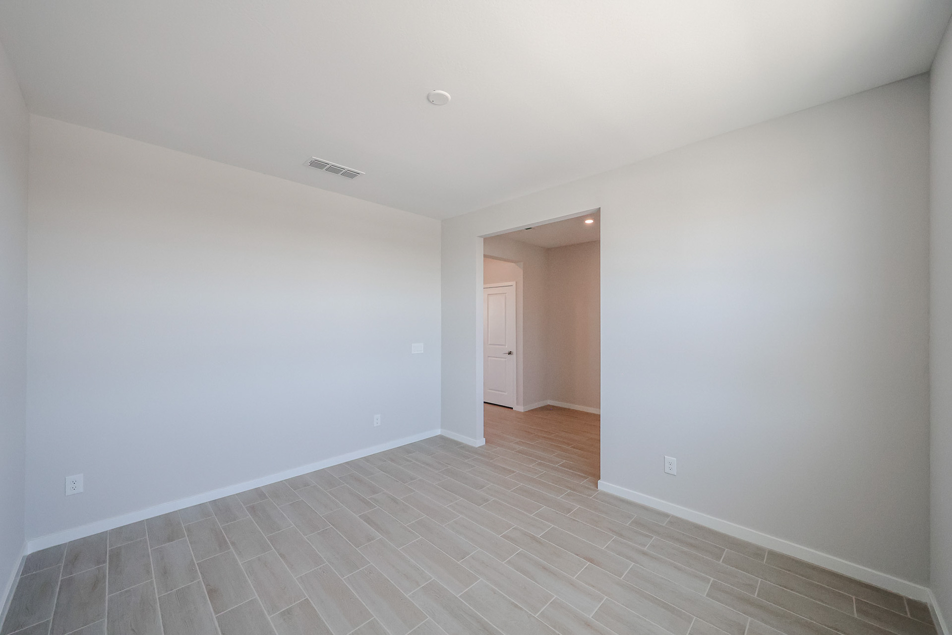 A hallway with white walls.