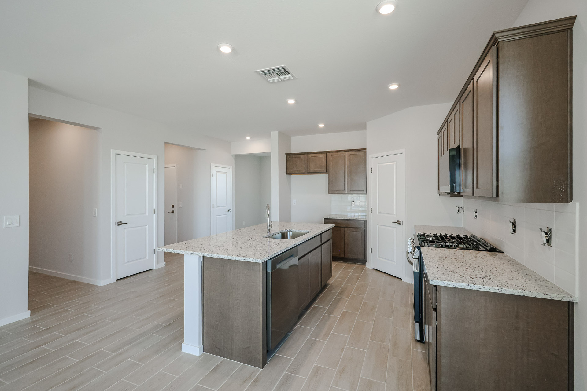 A kitchen with wooden cabinets.