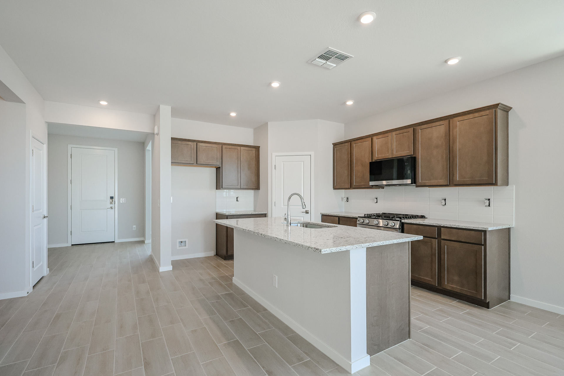 A kitchen with wooden cabinets.