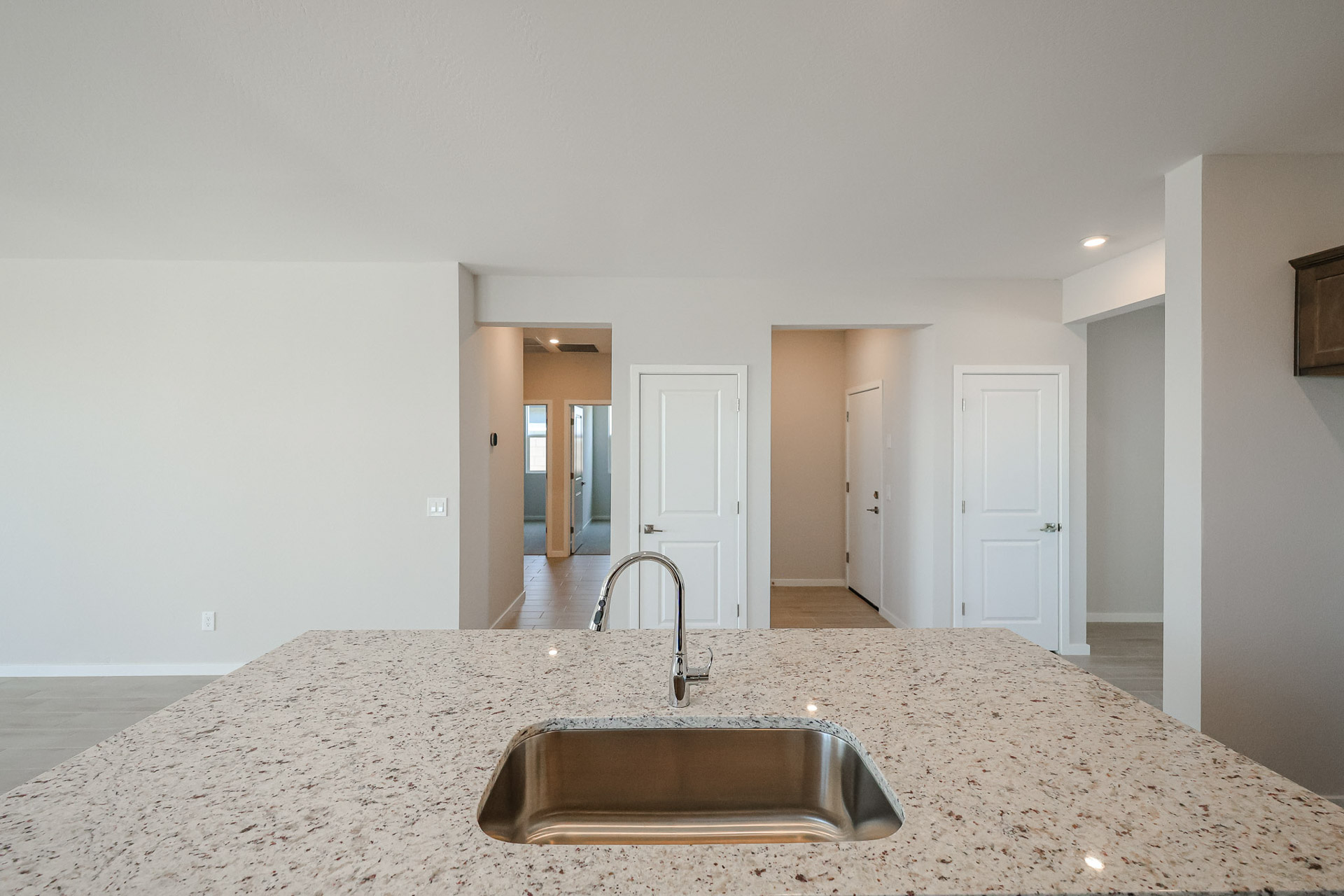A kitchen with marble countertop.