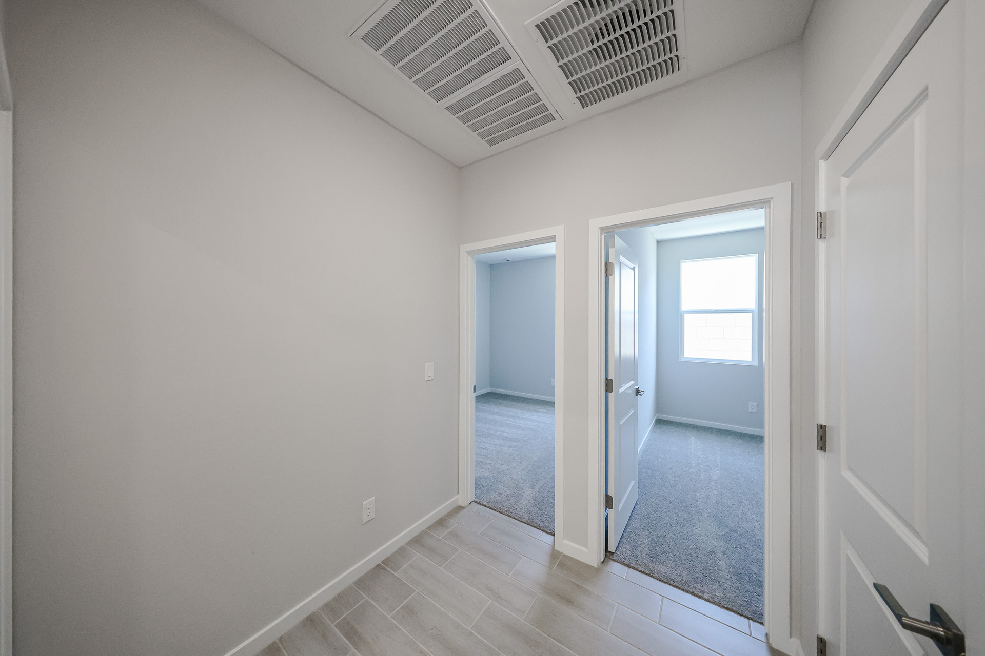 A hallway with white walls.