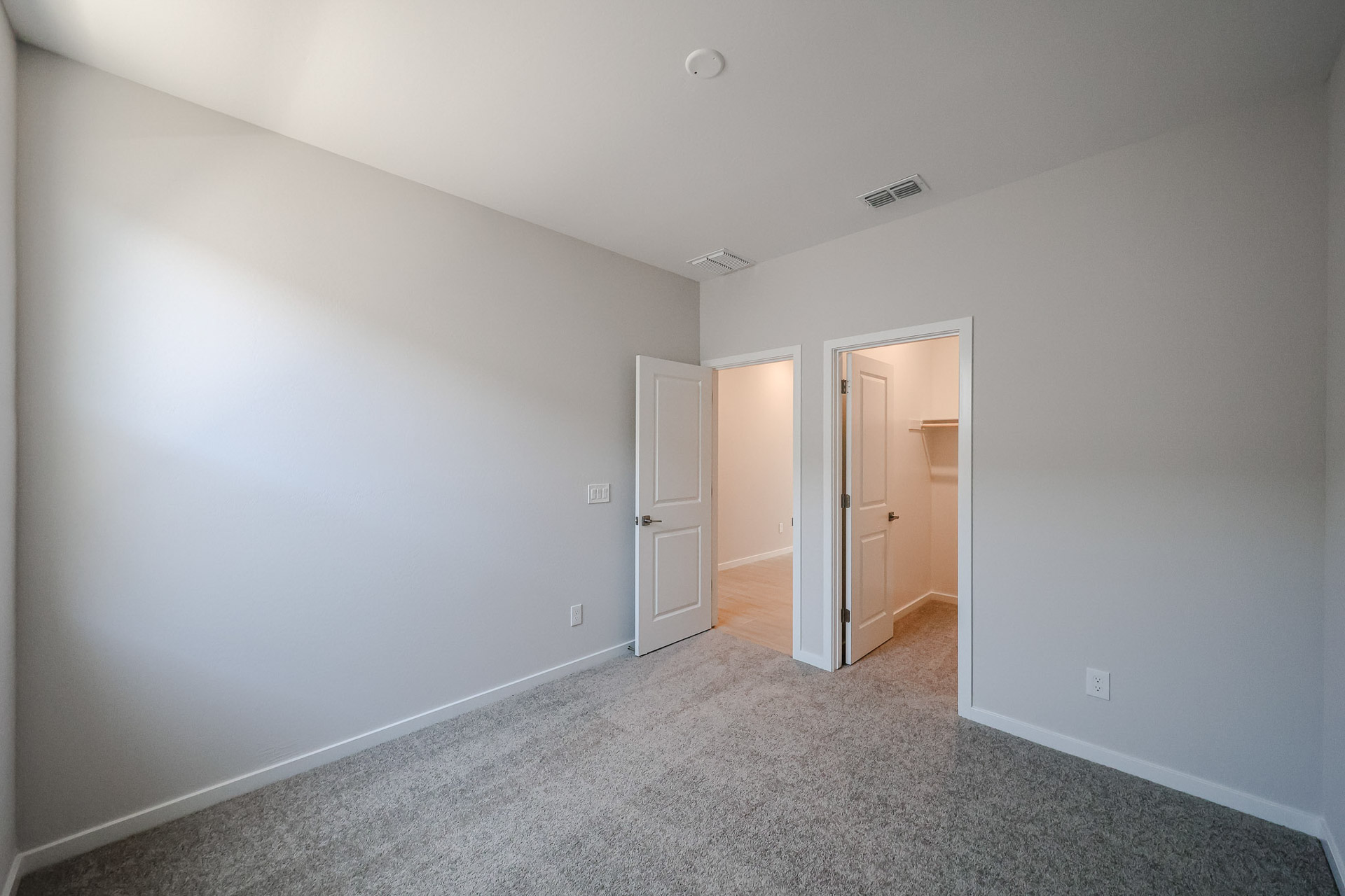 A hallway with white walls.