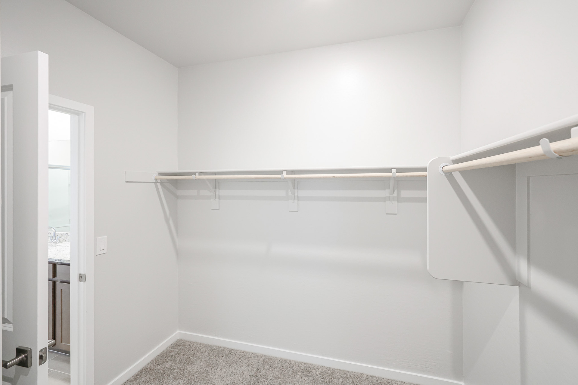 A white room with a metal railing.