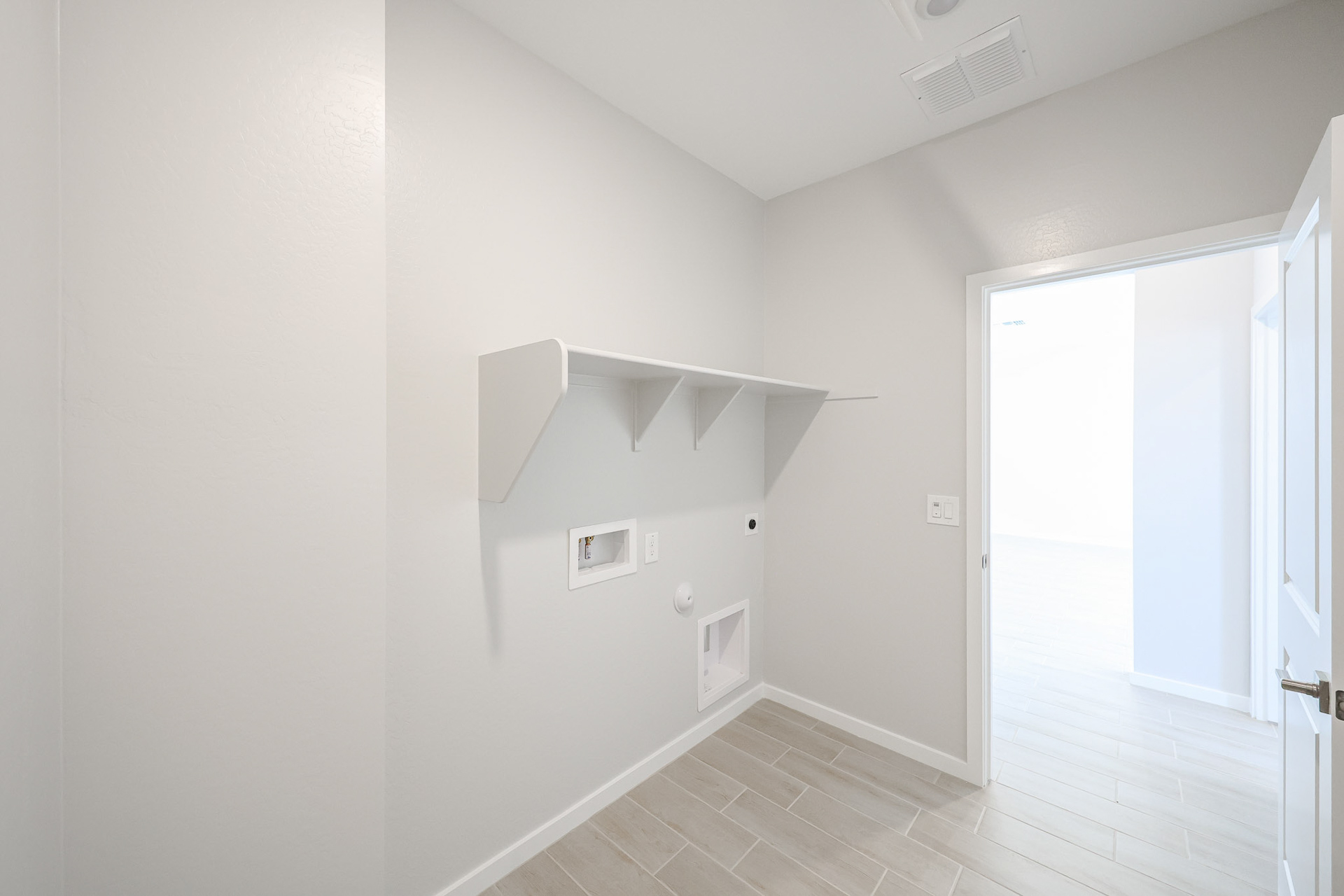 A hallway with white walls.