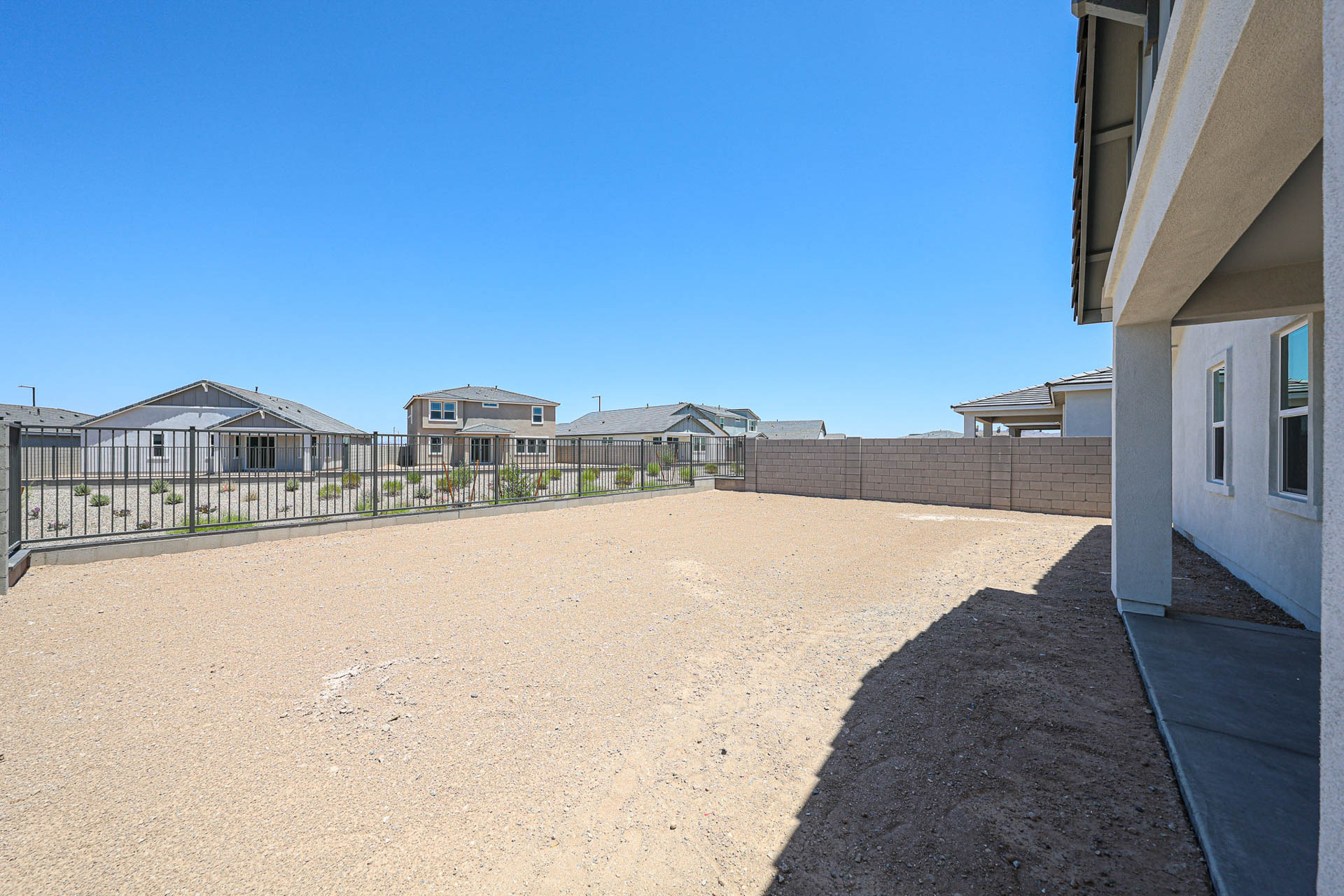 A dirt road between buildings.