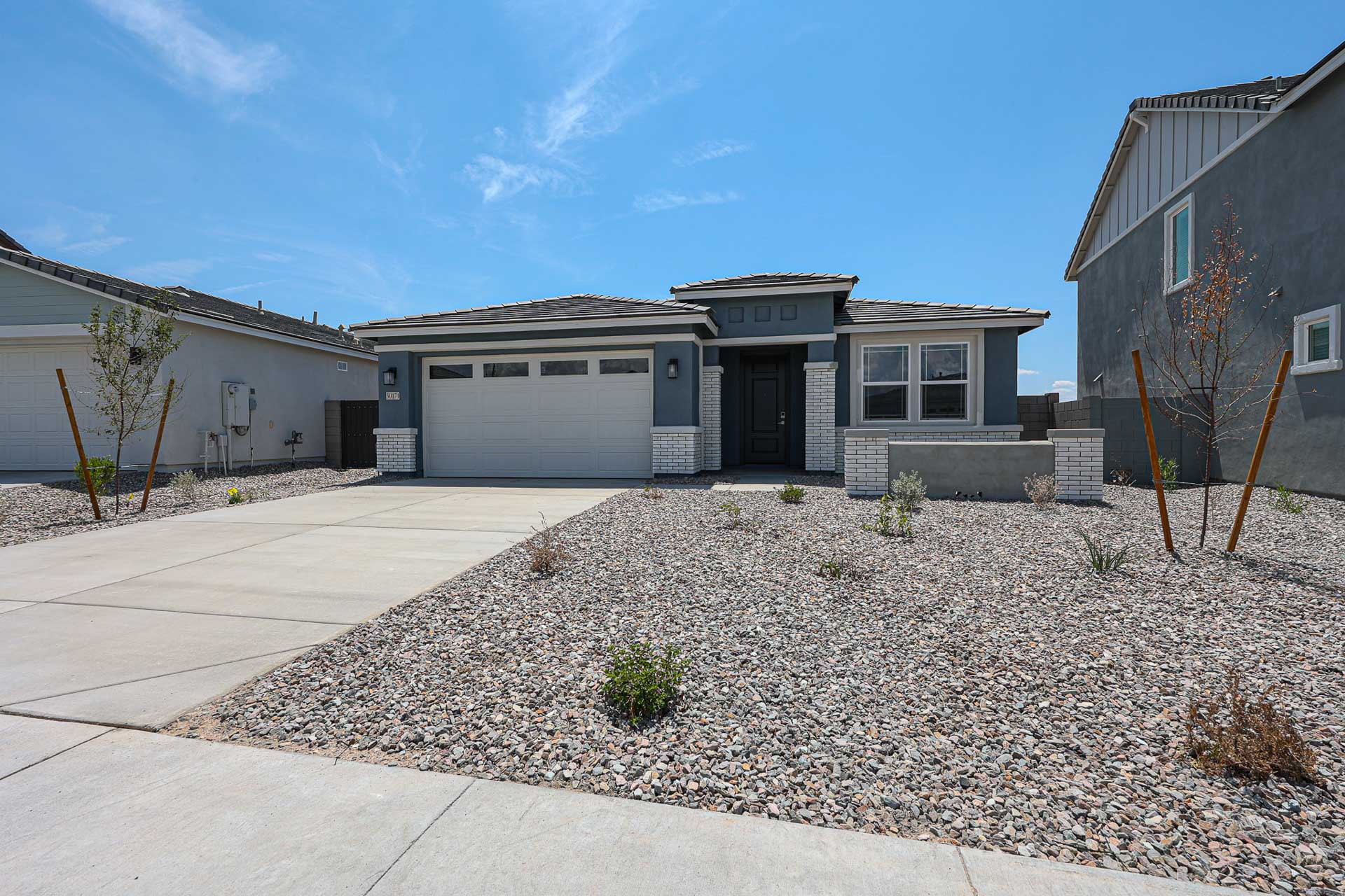 A building with a gravel driveway.