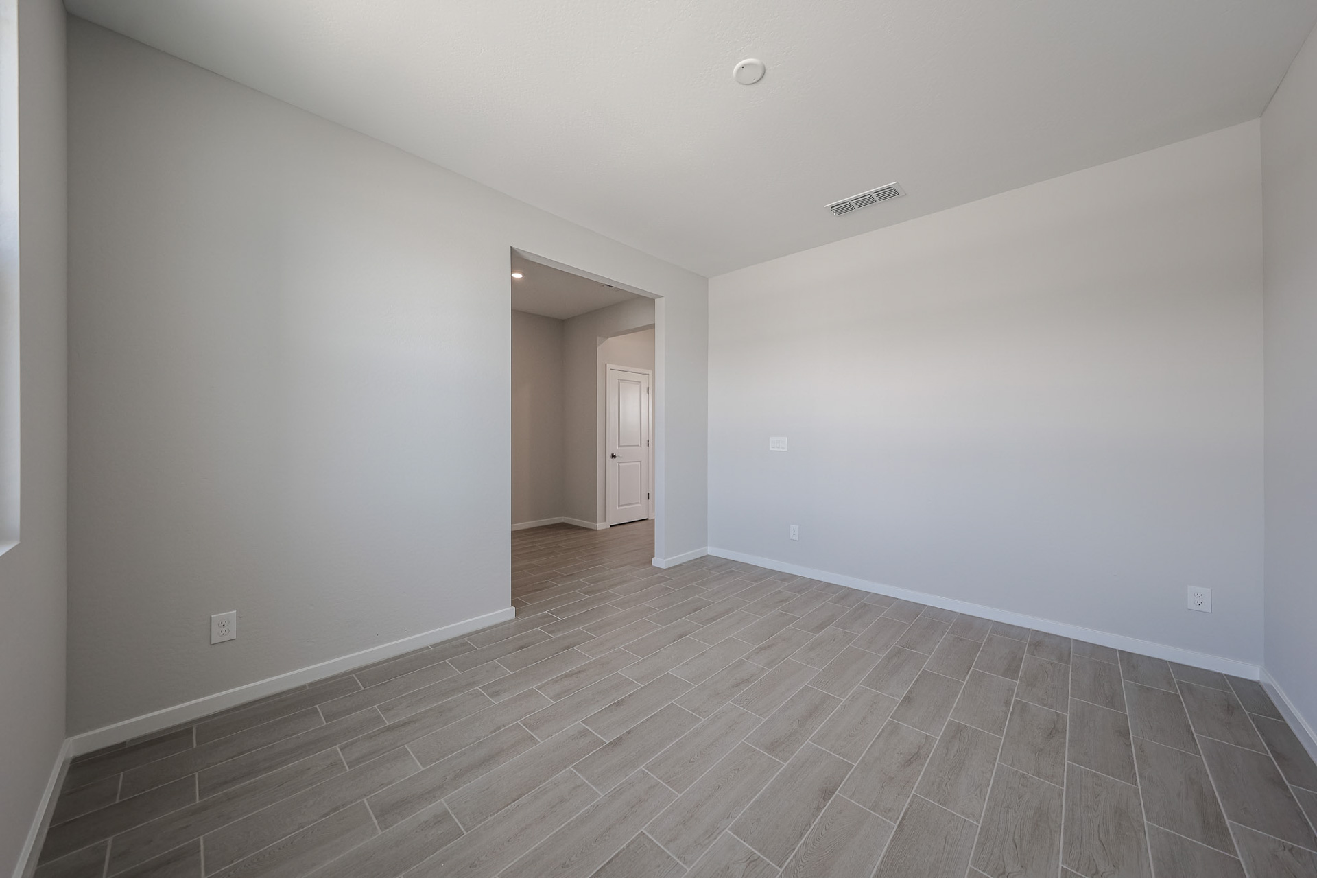 A hallway with white walls.