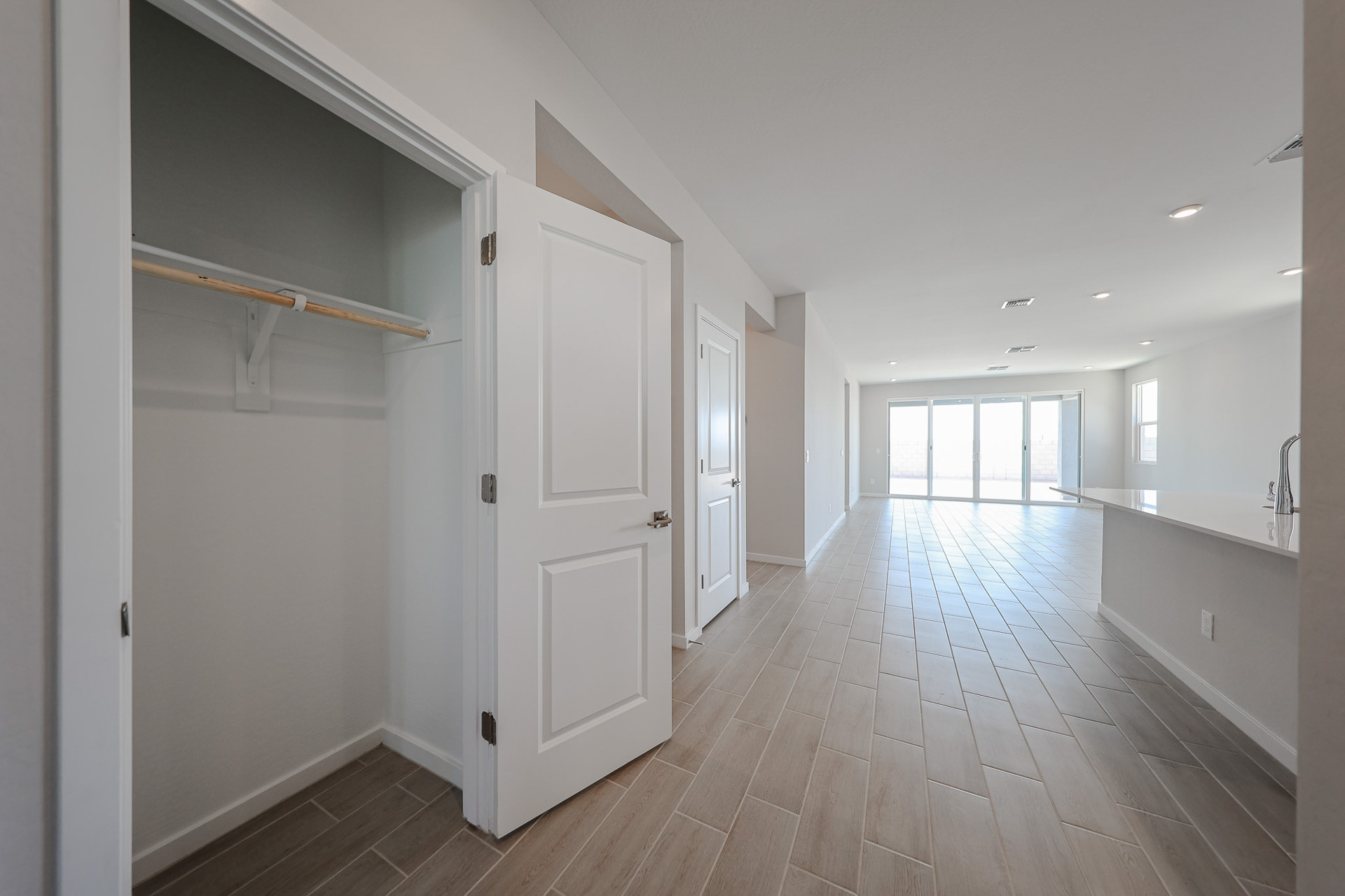 A long hallway with white doors.