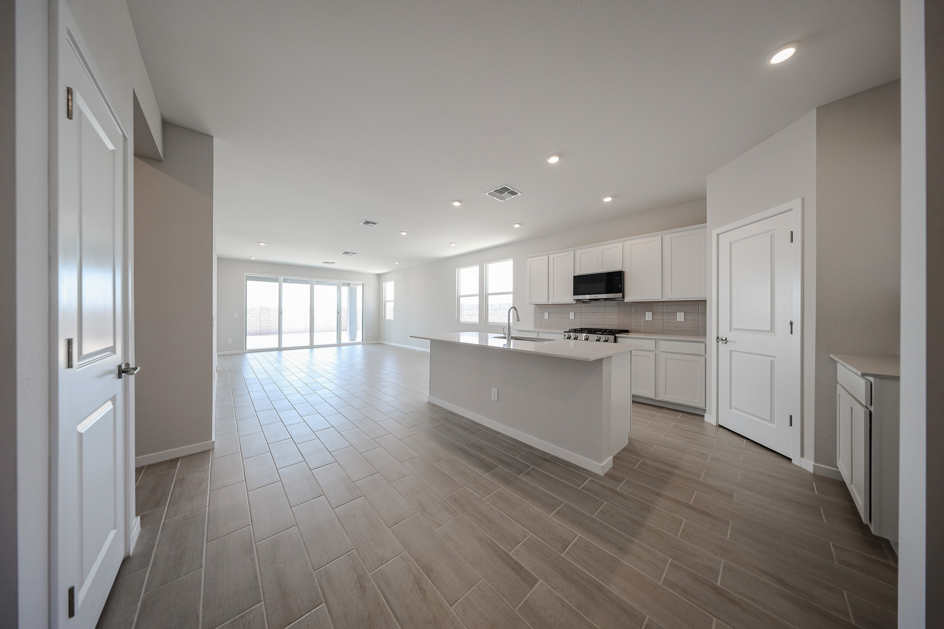 A large kitchen with white cabinets.