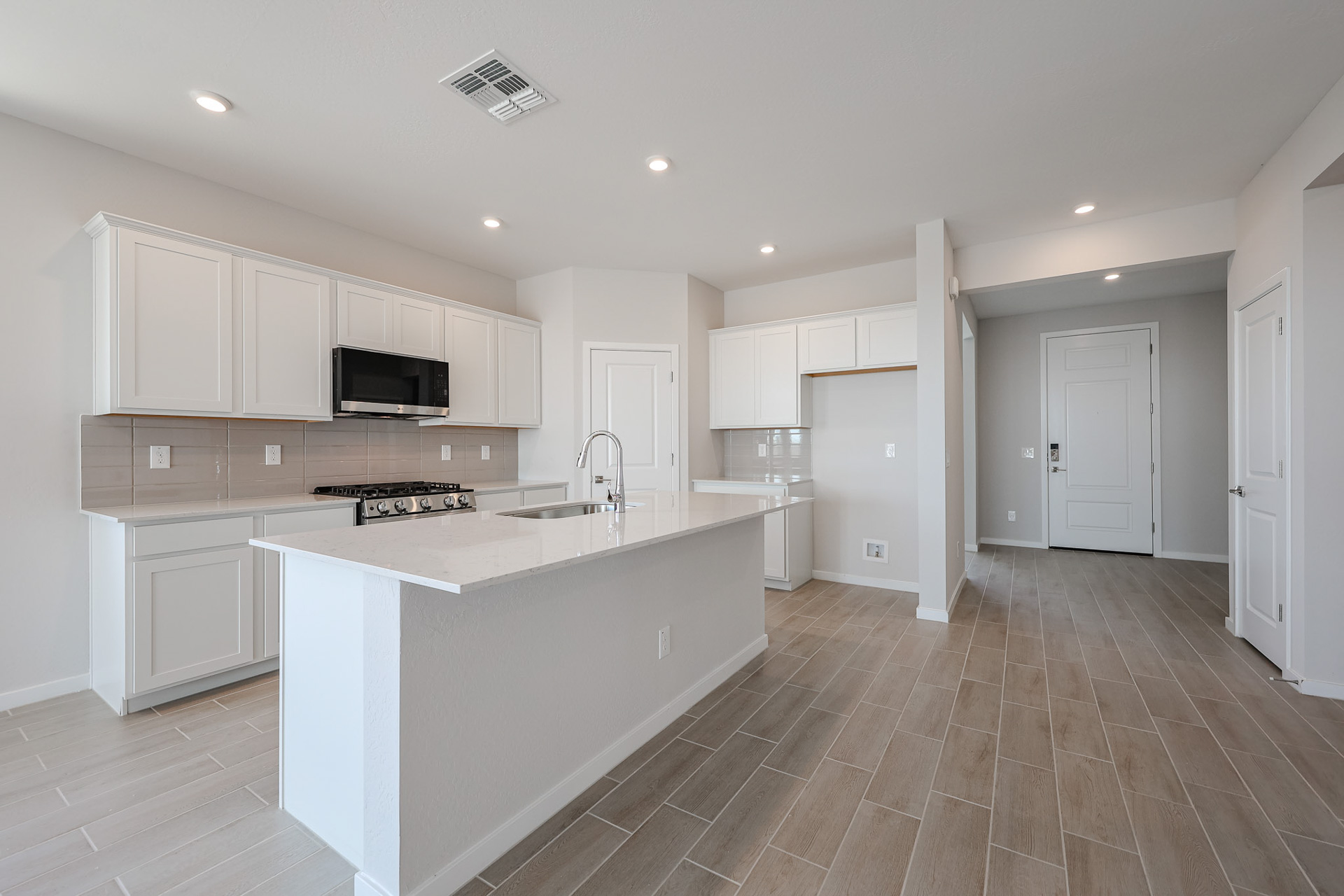A kitchen with white cabinets.